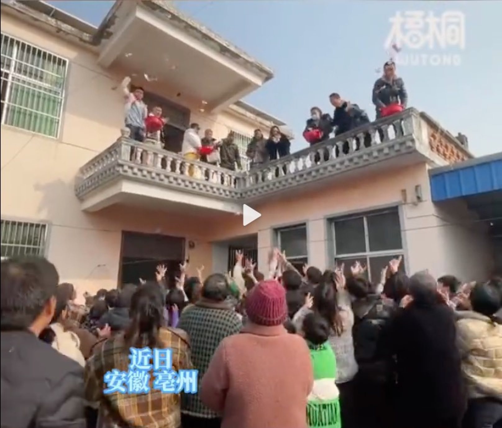 Guests lost it when the family began throwing hundred yuan notes from their first-floor balcony during the party. Photo: Weibo
