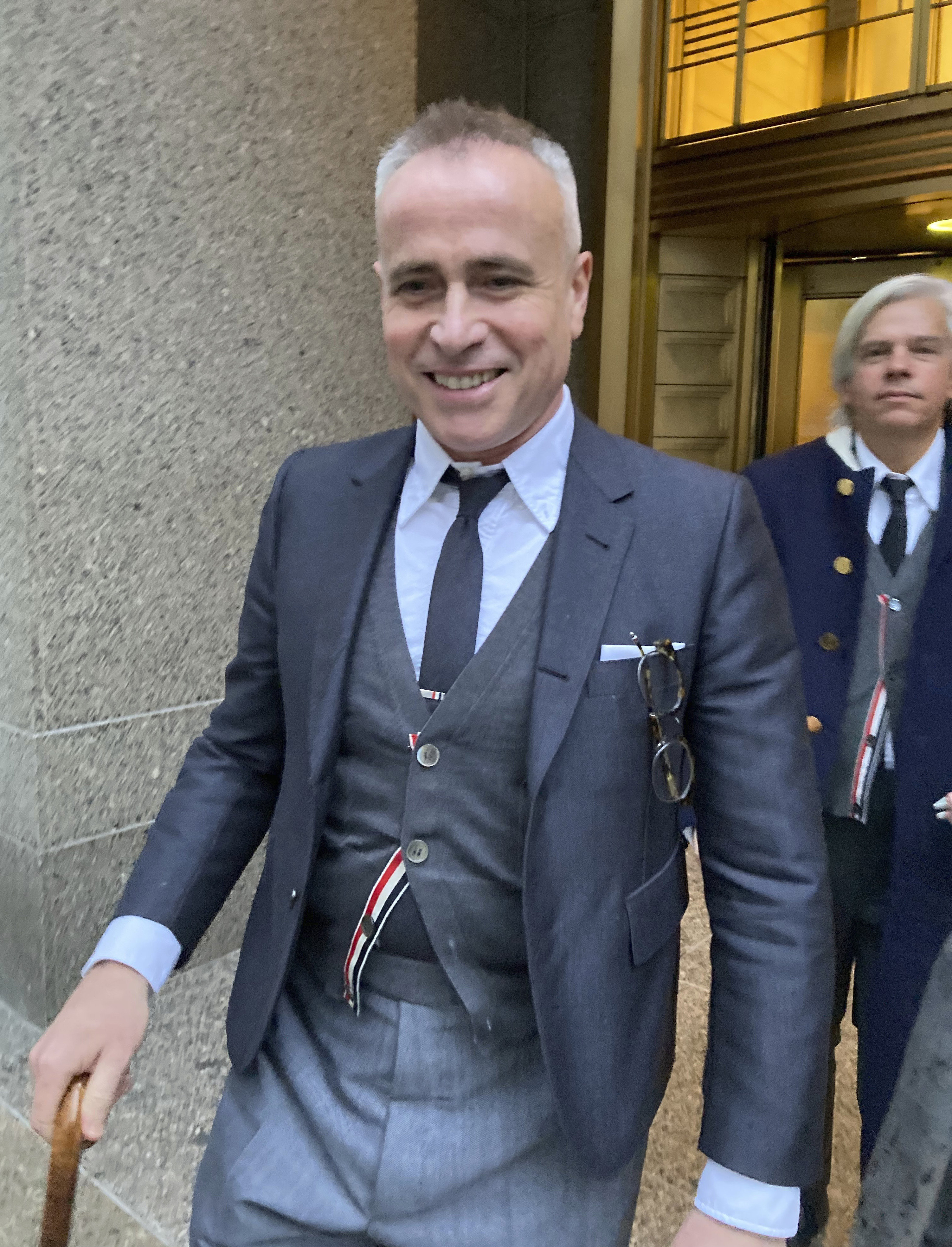 Fashion designer Thom Browne leaves Manhattan federal court after a jury decided he did not infringe the trademark of sportswear giant Adidas. Photo: AP