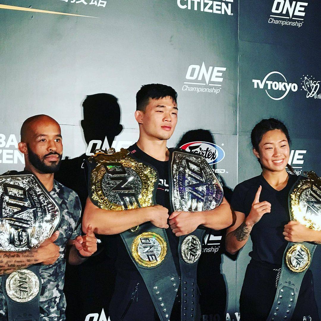 Demetrious Johnson (left) with Christian Lee and Angela Lee after their victories at ONE Century in Tokyo on October 12, 2019. Photo: Nicolas Atkin