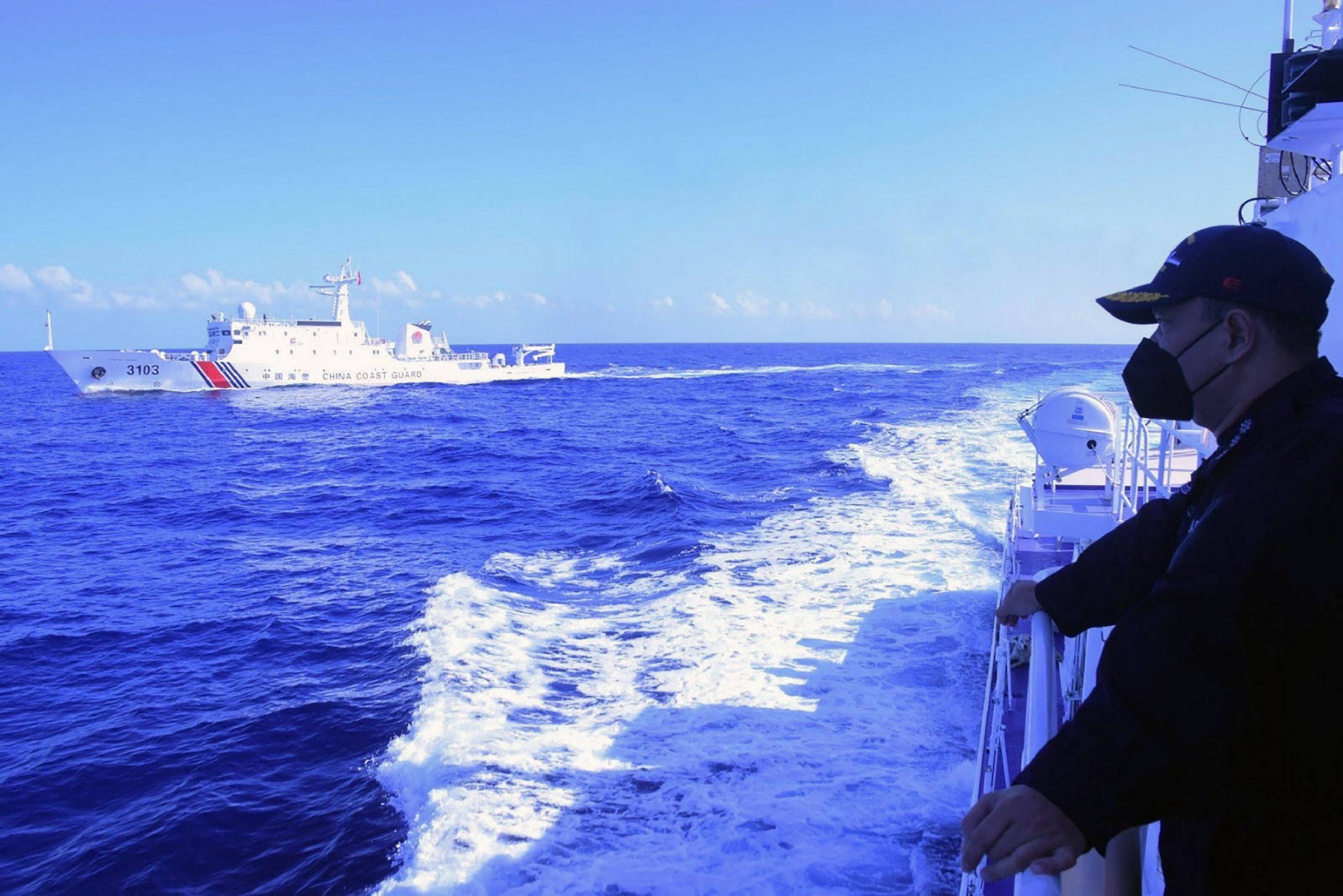 The Philippine coastguard monitors a Chinese patrol ship in a disputed area of the South China Sea. Photo: AFP