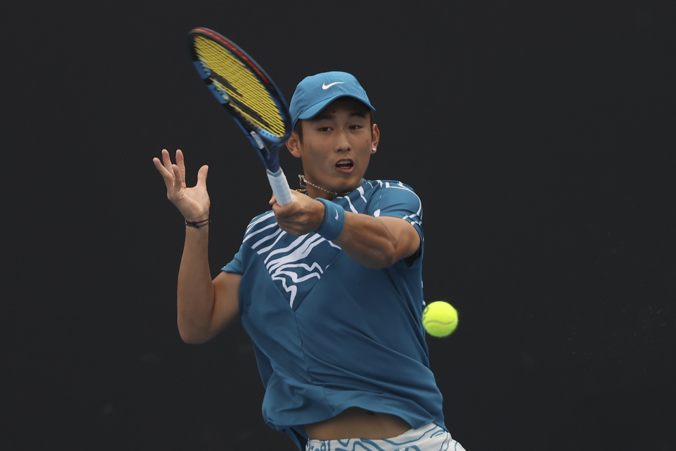 China’s Shang Juncheng hits a return during his first round men’s singles match against Oscar Otte at the Australian Open. Photo: EPA-EFE