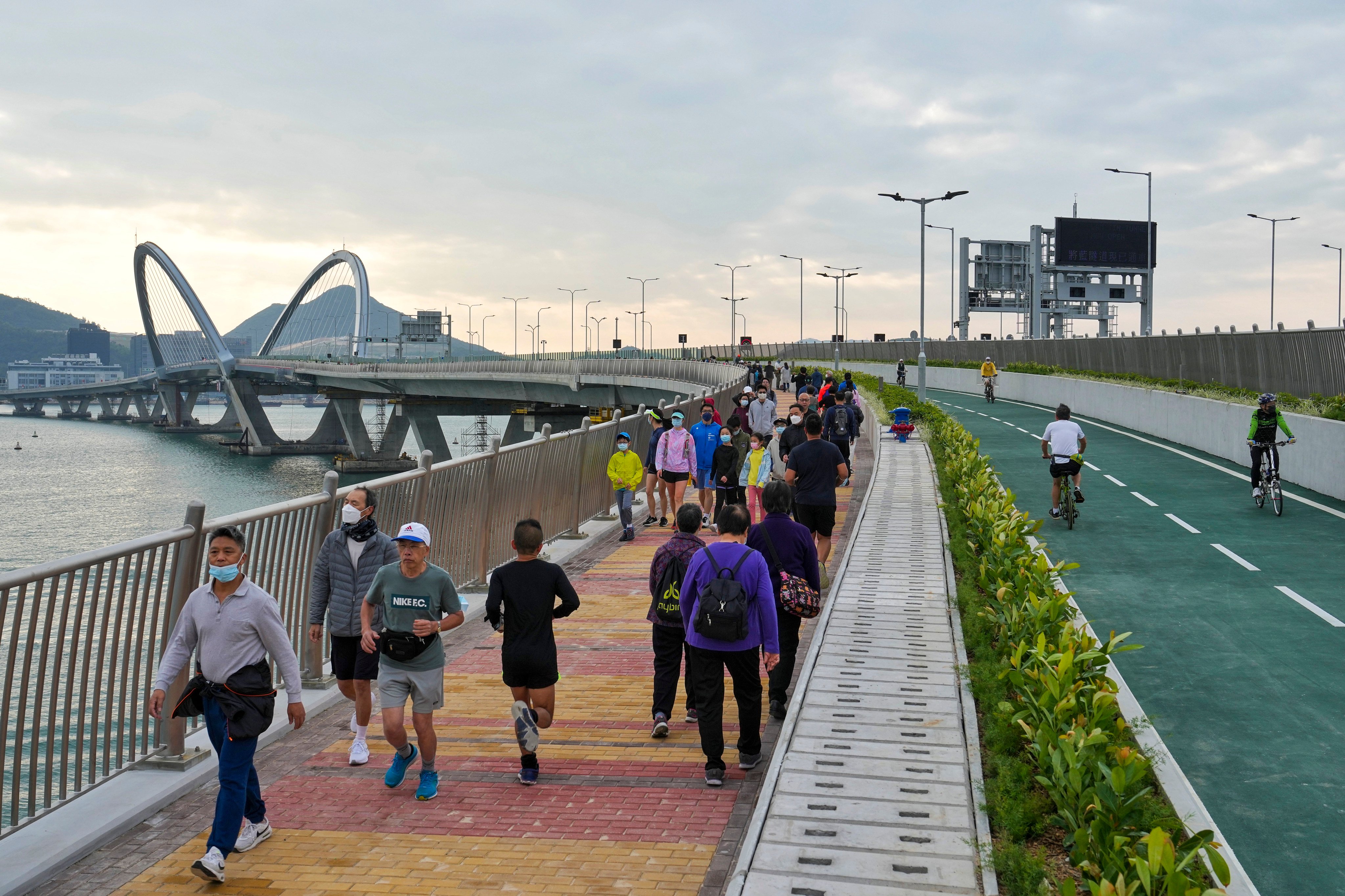 Runners and cyclists hit the Tseung Kwan O-Lam Tin Tunnel and the Cross Bay Link on opening day on December 11, 2022. To tackle air pollution, Hong Kong needs to become a more accessible and bicycle-friendly city. Photo: Elson Li
