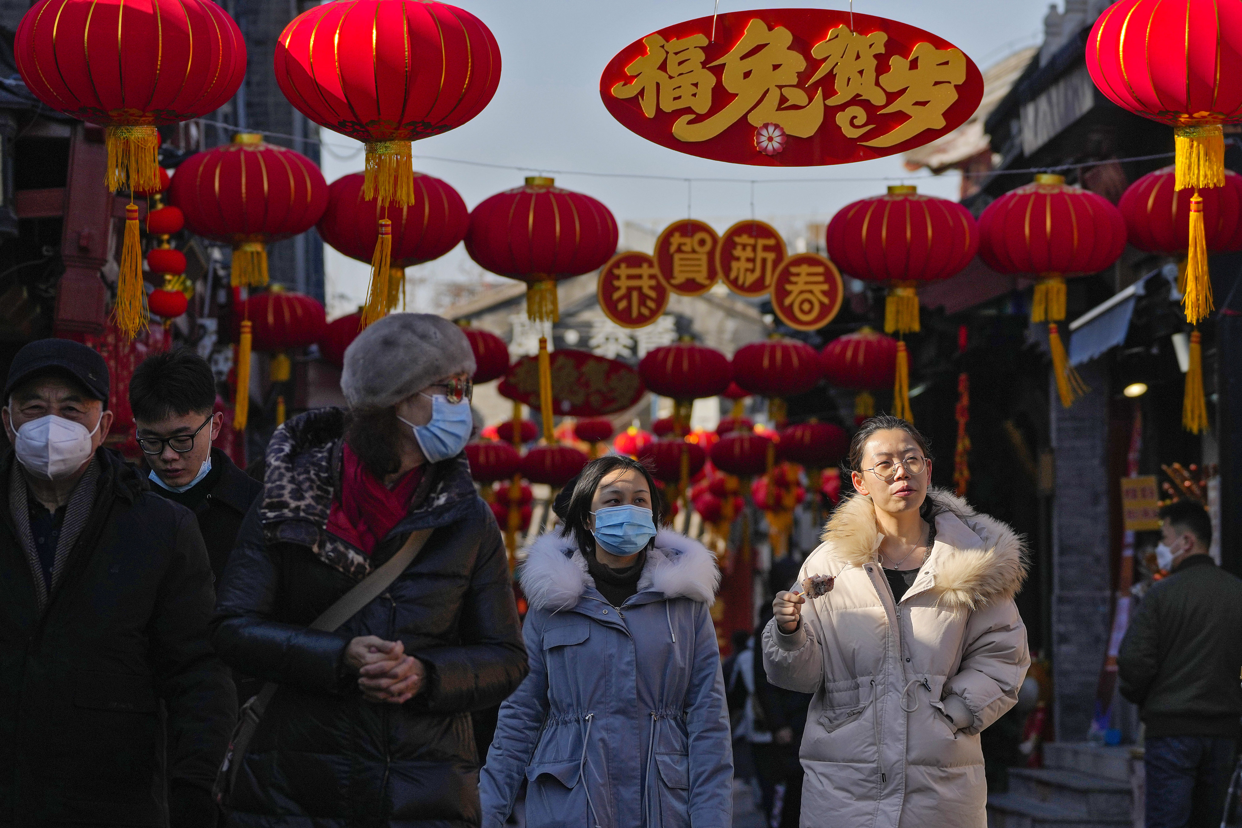 Visitors tour a shopping alley near the Houhai Lake in Beijing. Photo: AP