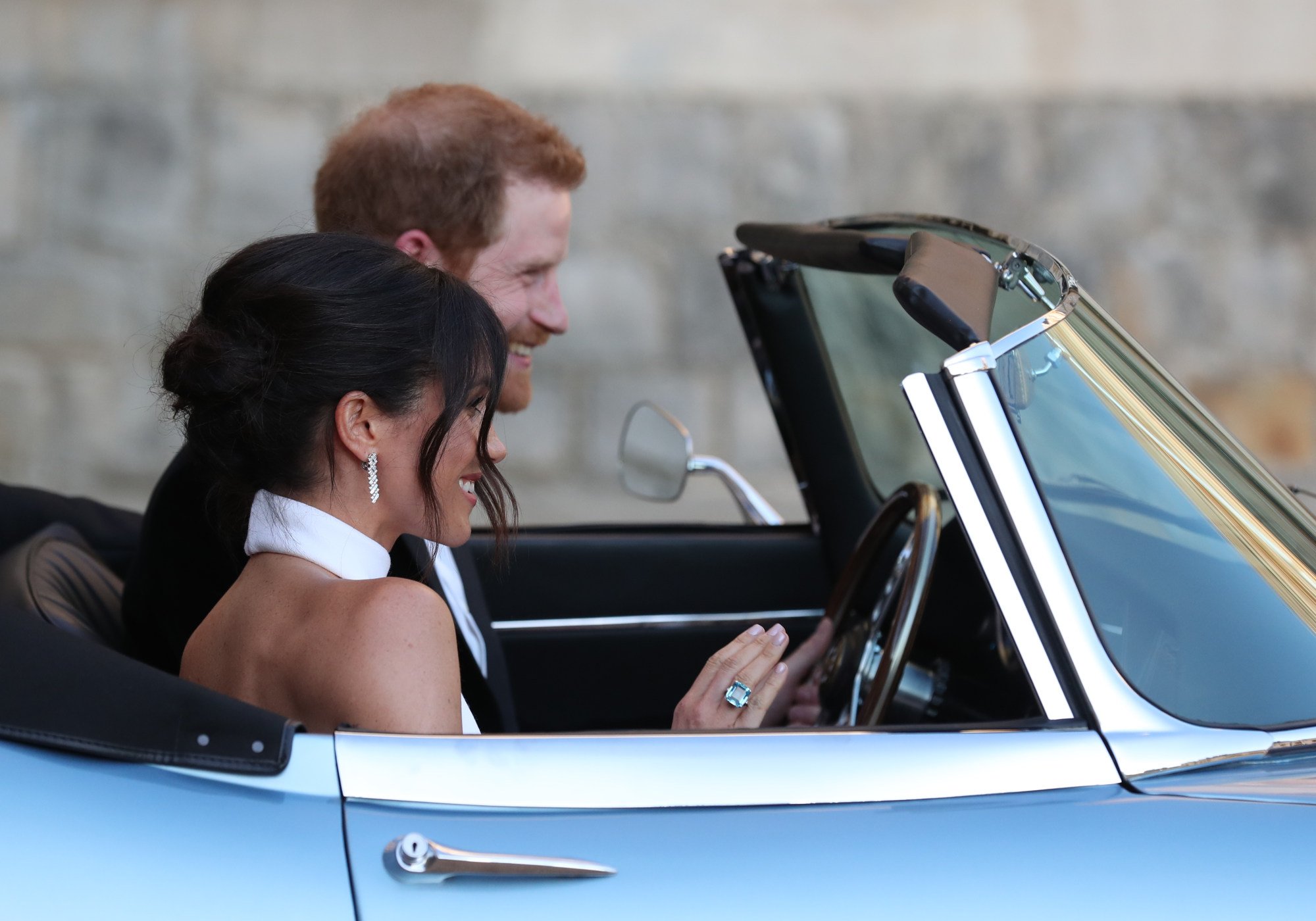 Fans got a glimpse of Meghan Markle’s stunning jewellery for her wedding reception as she drove past crowds alongside Prince Harry on her big day. Photo: Getty Images