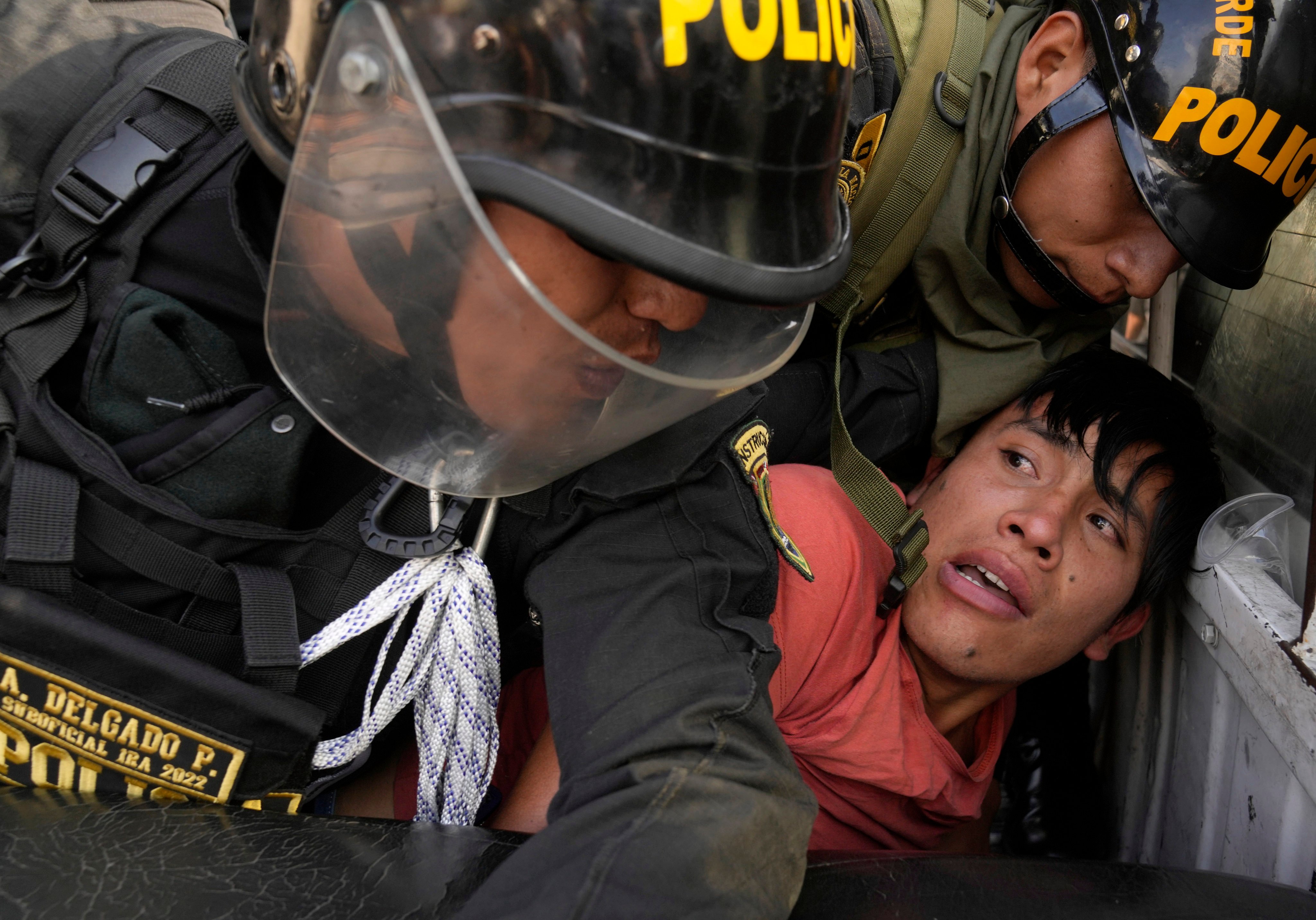 Police detain a person during anti-government clashes in Lima, Peru. Photo: AP