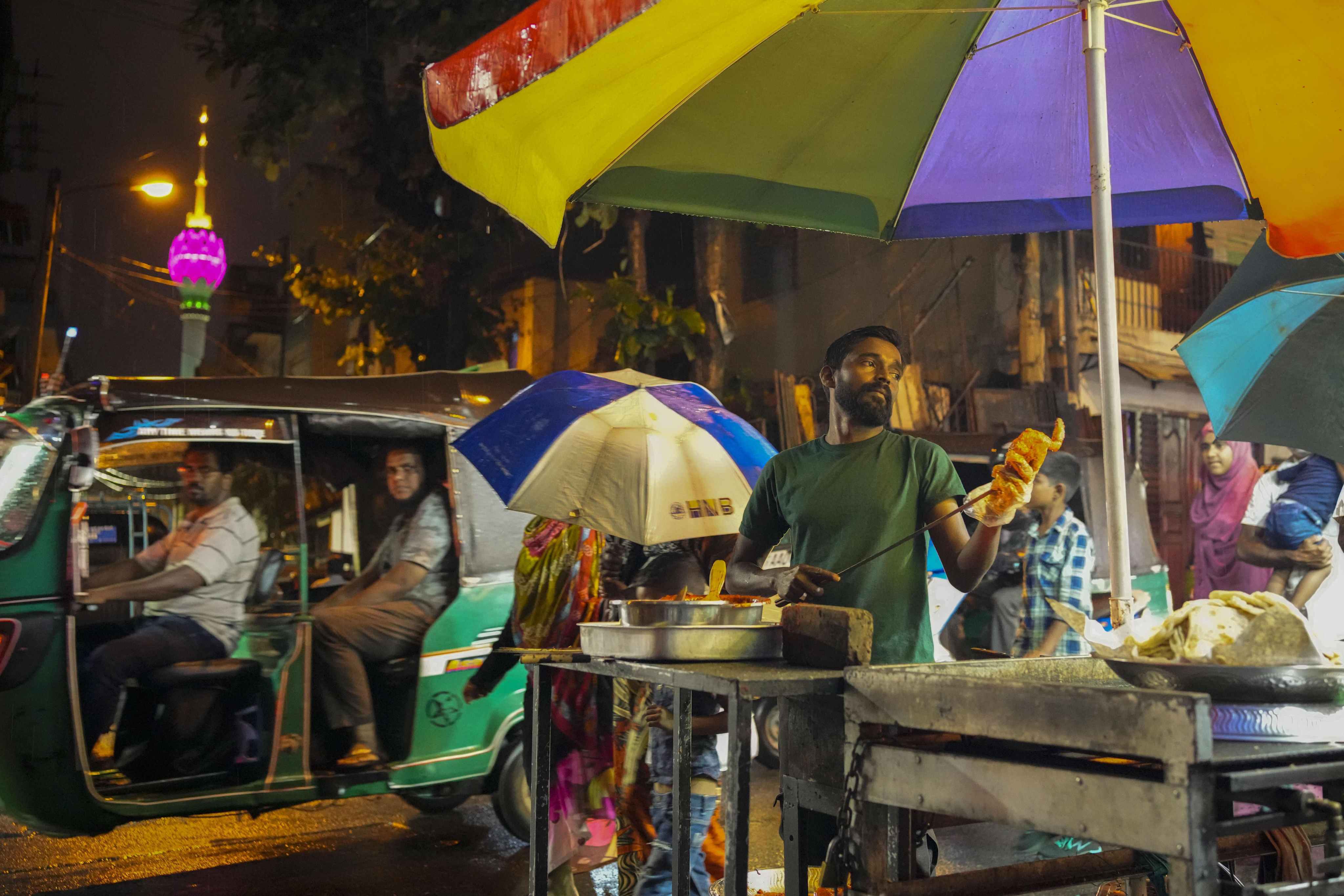 A street vendor prepares food in Colombo in December 2022. Sri Lanka has about US$50 billion in foreign currency debt. Photo: AP
