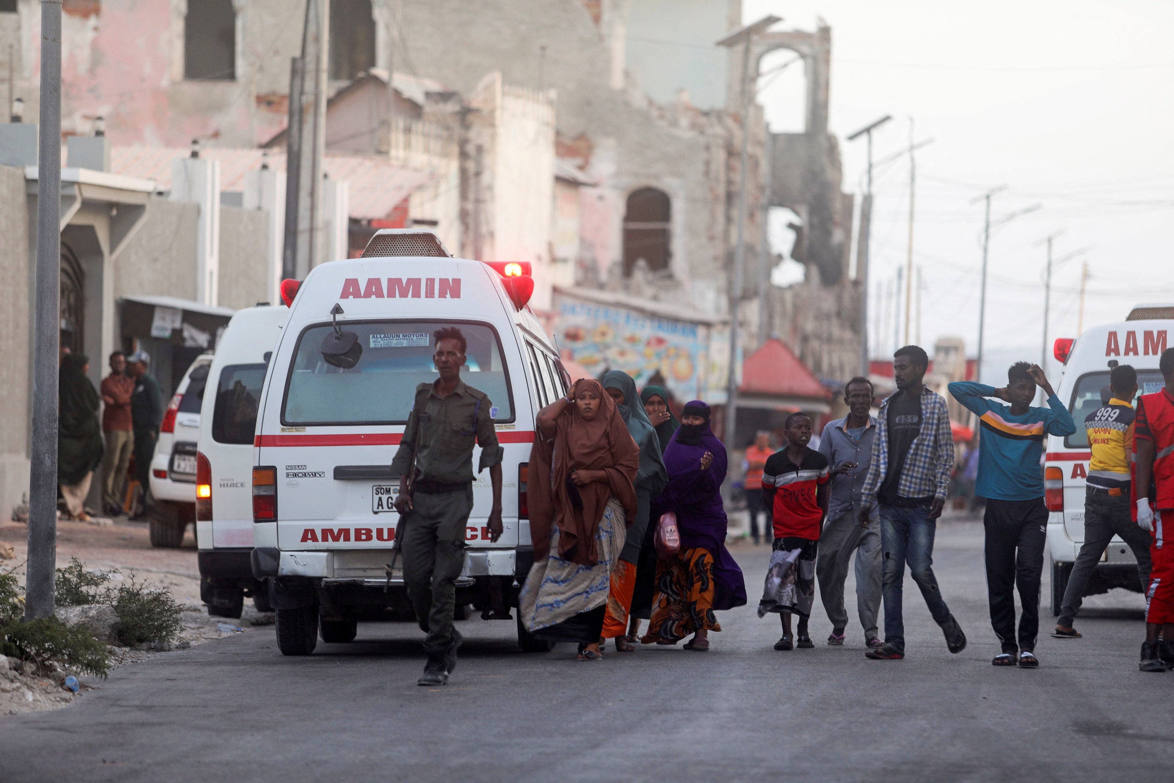 Somali security forces and civilians walk to view the bodies of suspected al-Shabab fighters killed in a clash with security members at the mayor’s office in Mogadishu, Somalia on Sunday. Photo: Reuters . 