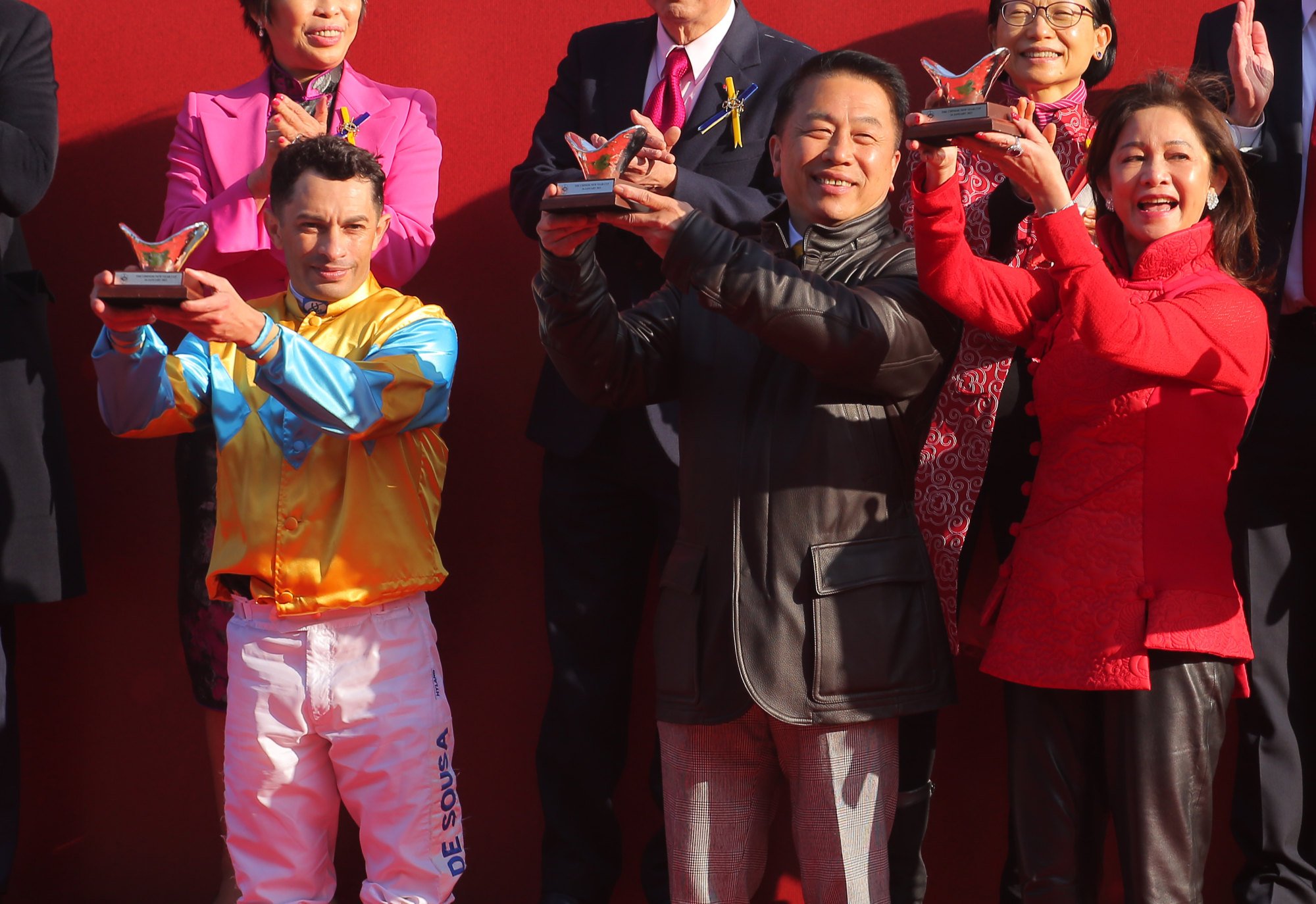 Jockey Silvestre de Sousa, trainer Ricky Yiu and connections collect their trophies.