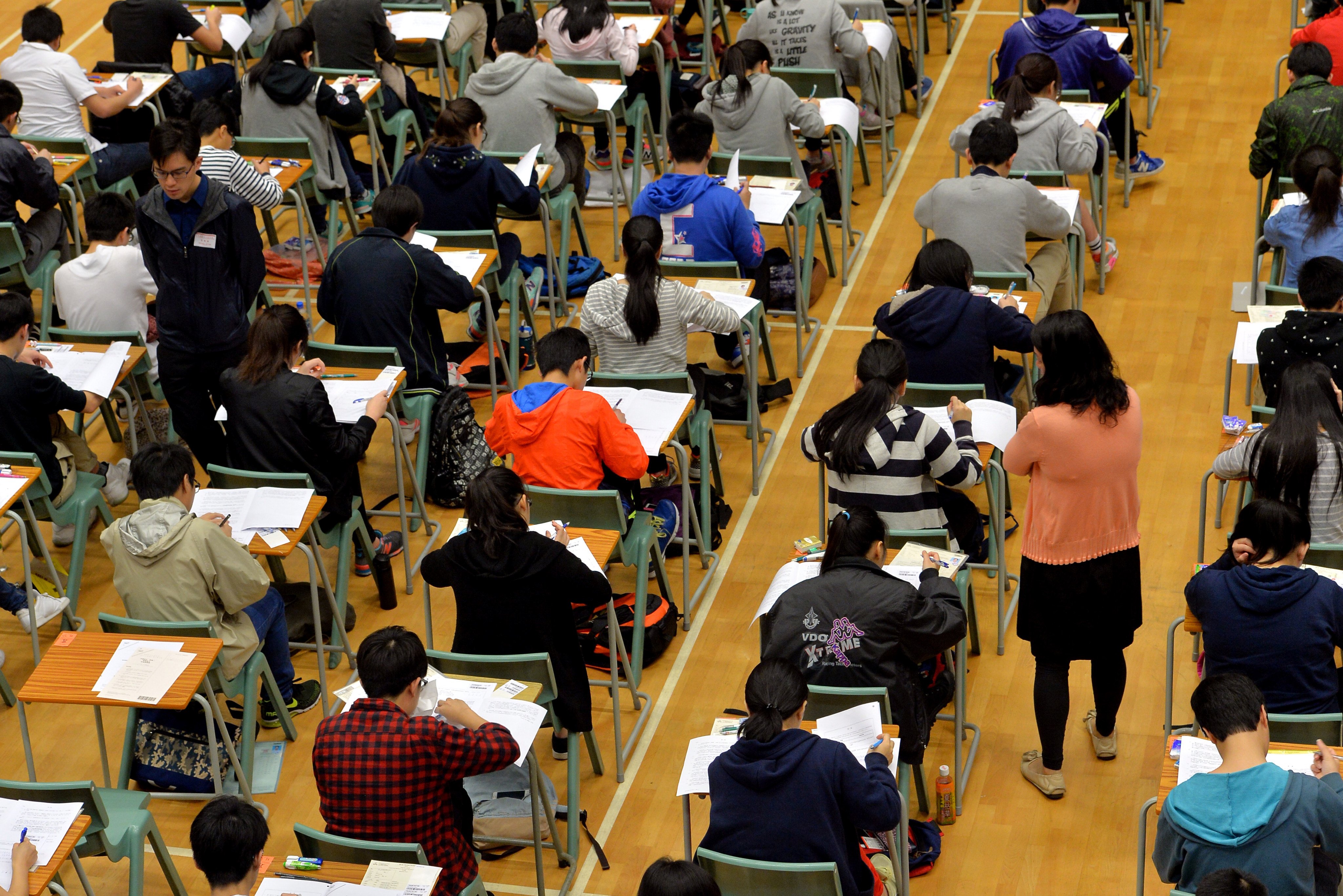 Students take the Hong Kong Diploma of Secondary Education examination in Shek Kip Mei. The rise of ChatGPT and other AI advances does not necessarily herald the end of traditional education any more than calculators made arithmetic obsolete. Photo: SCMP
