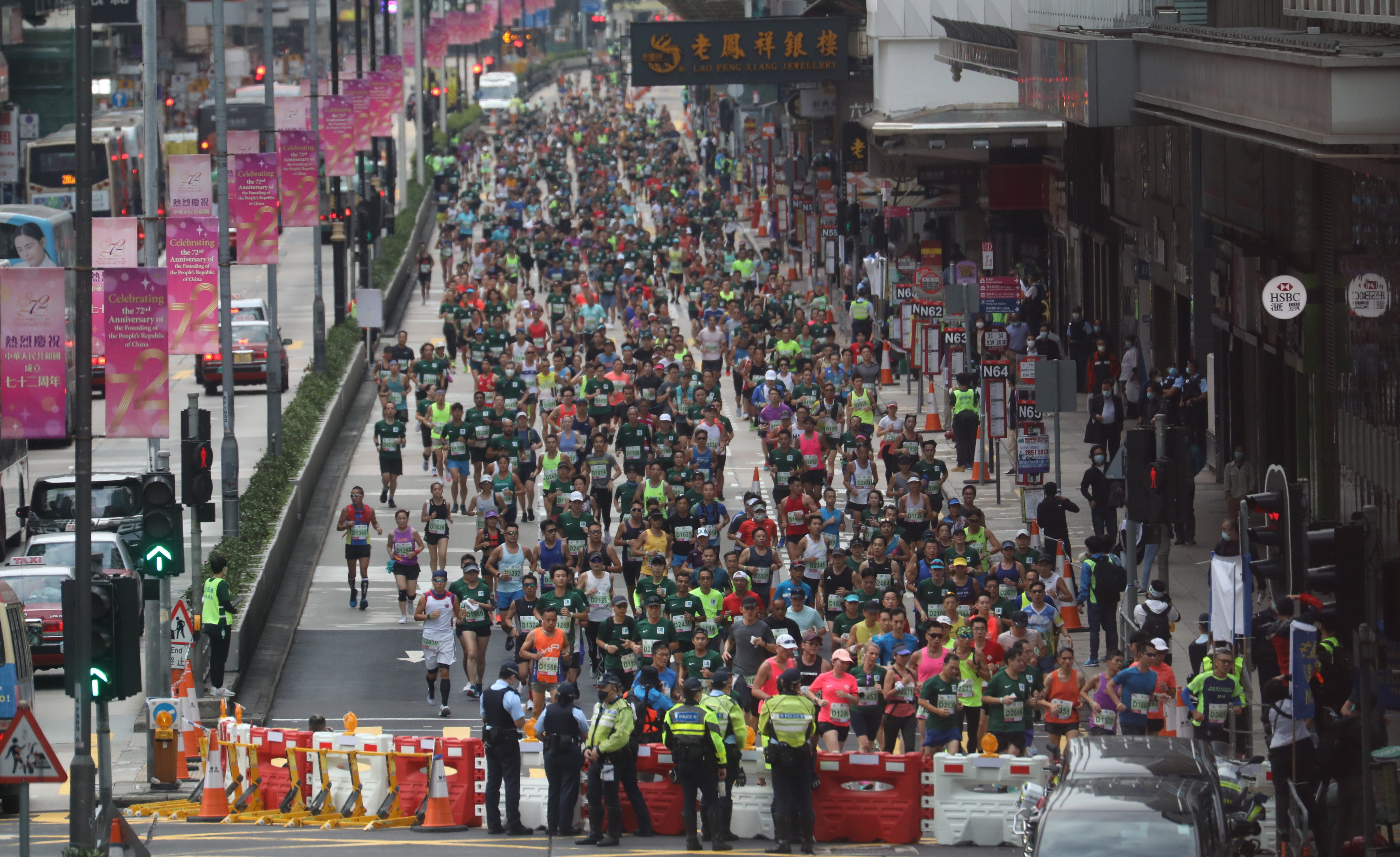 Participants run through Nathan Road in Mong Kok during the 2021 Standard Chartered Hong Kong Marathon. Photo: Winson Wong