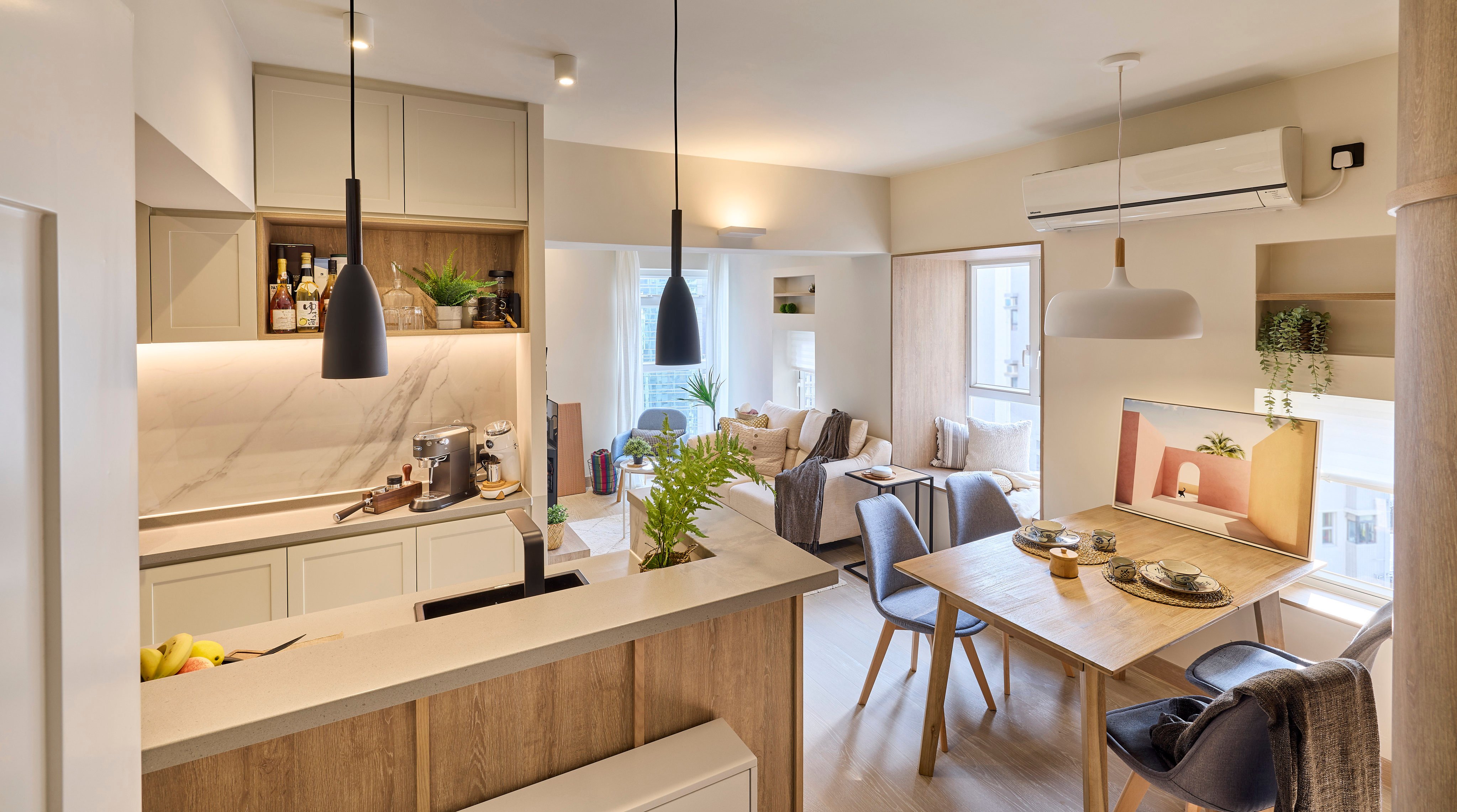 The kitchen, dining and sitting areas of Kenneth Yuen and Sabrina Jensen’s redesigned 397 sq ft apartment in Hong Kong’s Wan Chai district. Photo:  Michael Perini