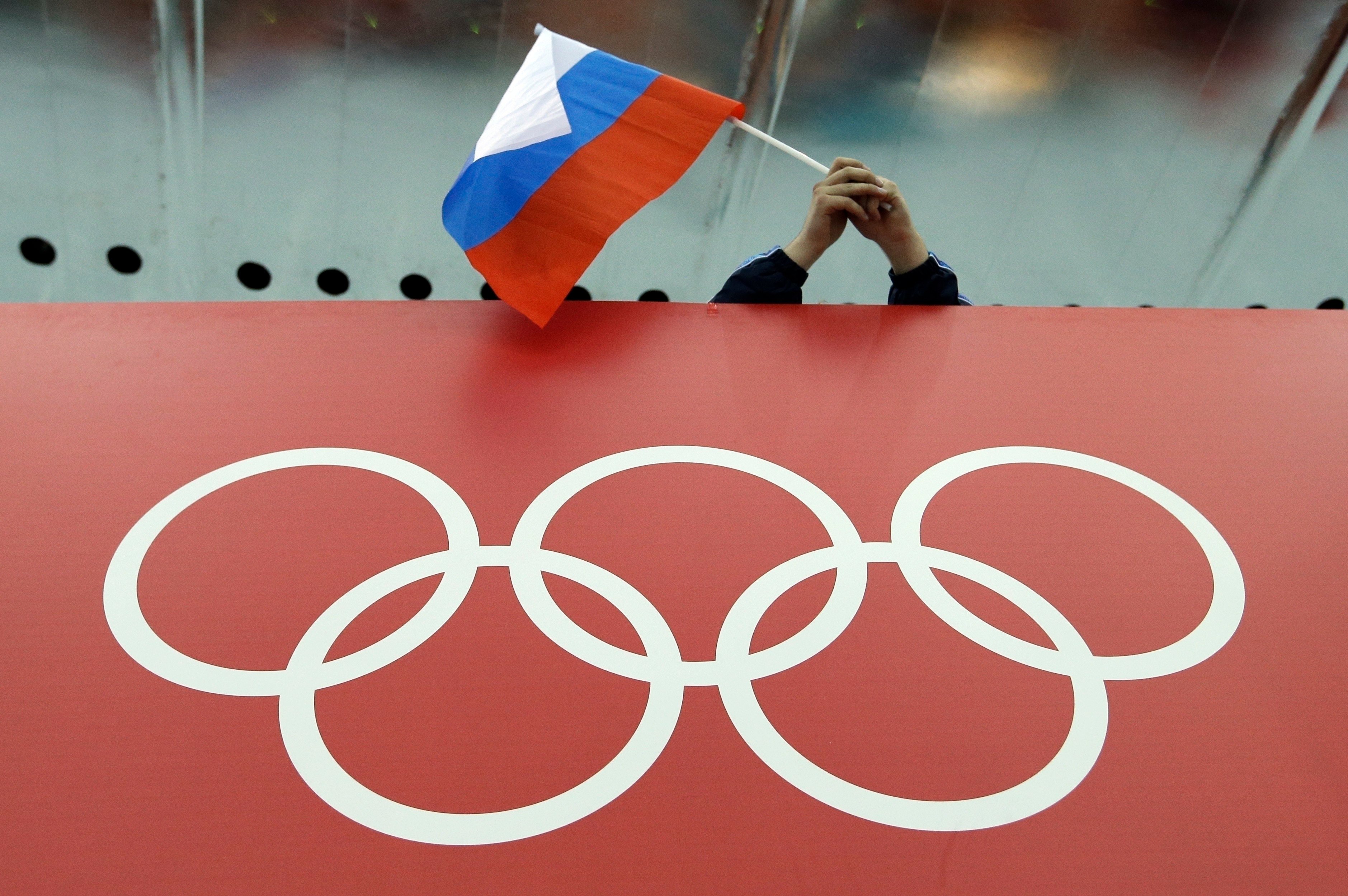 A Russian flag held above the Olympic Rings during the Winter Olympics in 2014. Photo: AP