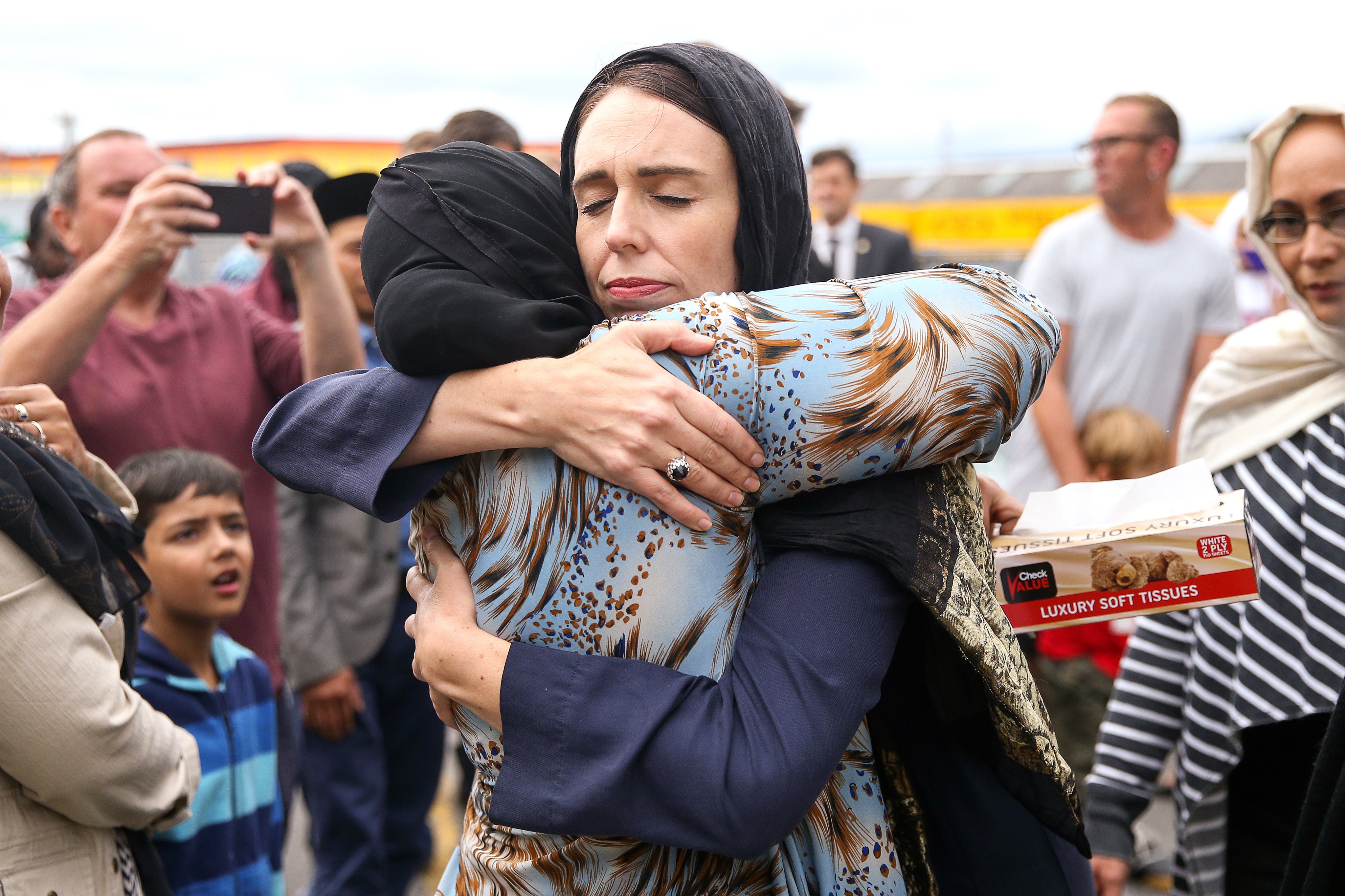 Prime Minister Jacinda Ardern, wearing a hijab, comforts a woman in the days after 2019’s Christchurch mosque shootings. Photo: Getty Images