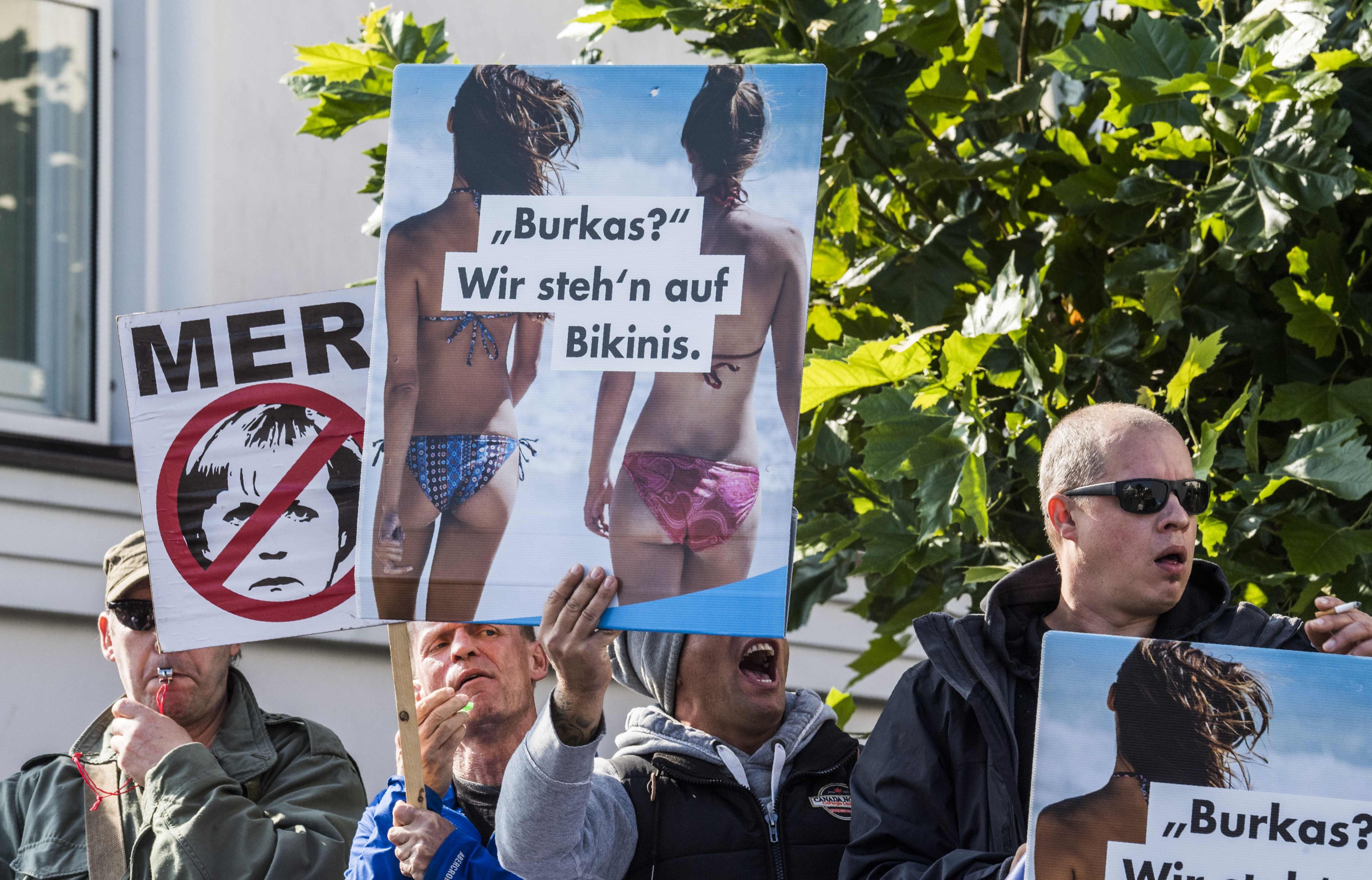 Members of the far-right, anti-immigrant Alternative for Germany display placards during a protest in Binz on September 16, 2017. The main placard reads: “Burkas? We prefer prefer bikinis.” Photo: AFP