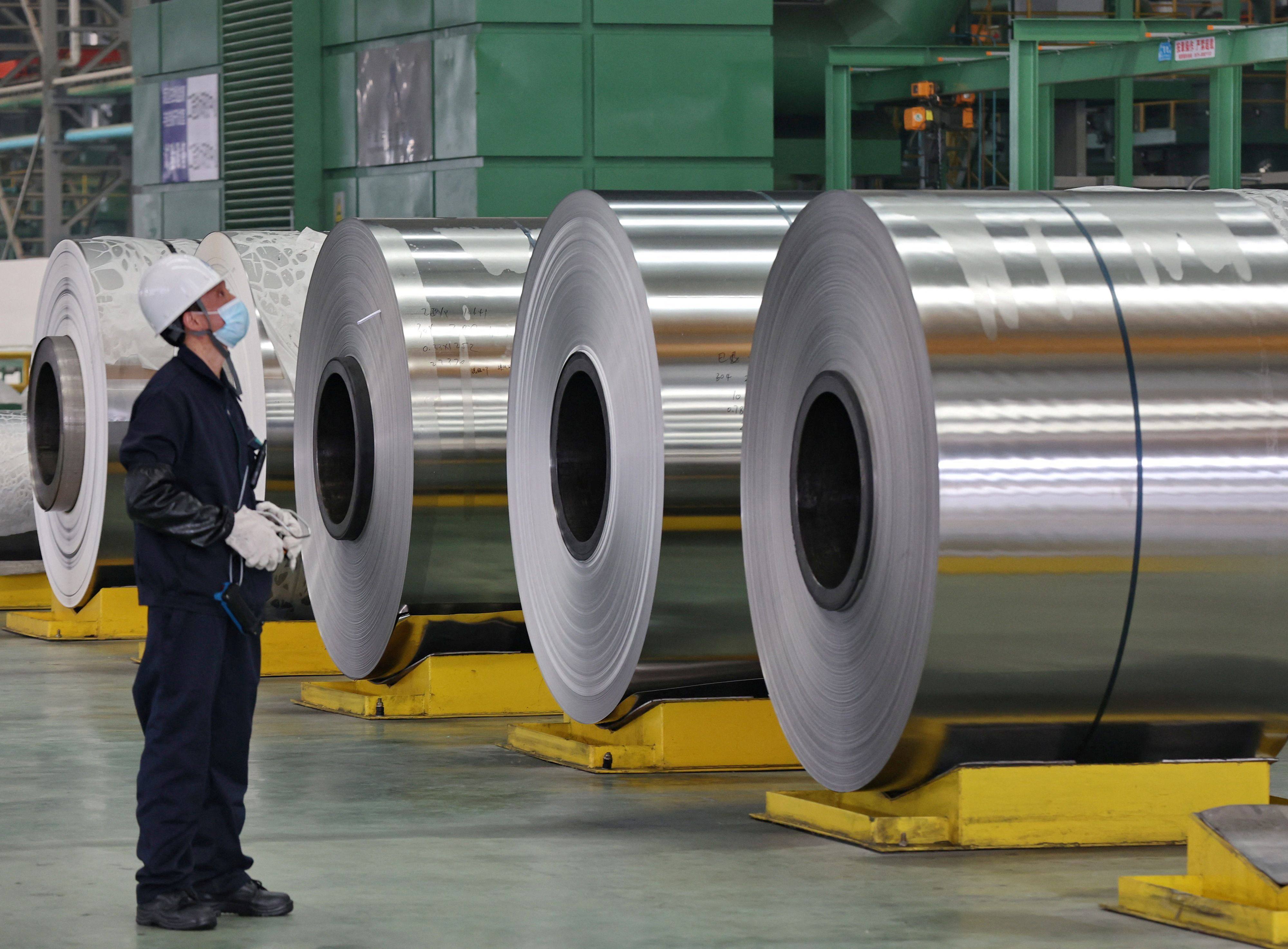 An employee looks on at steel rolls at a factory in Nantong in China’s eastern Jiangsu province in March 2022. Photo: AFP