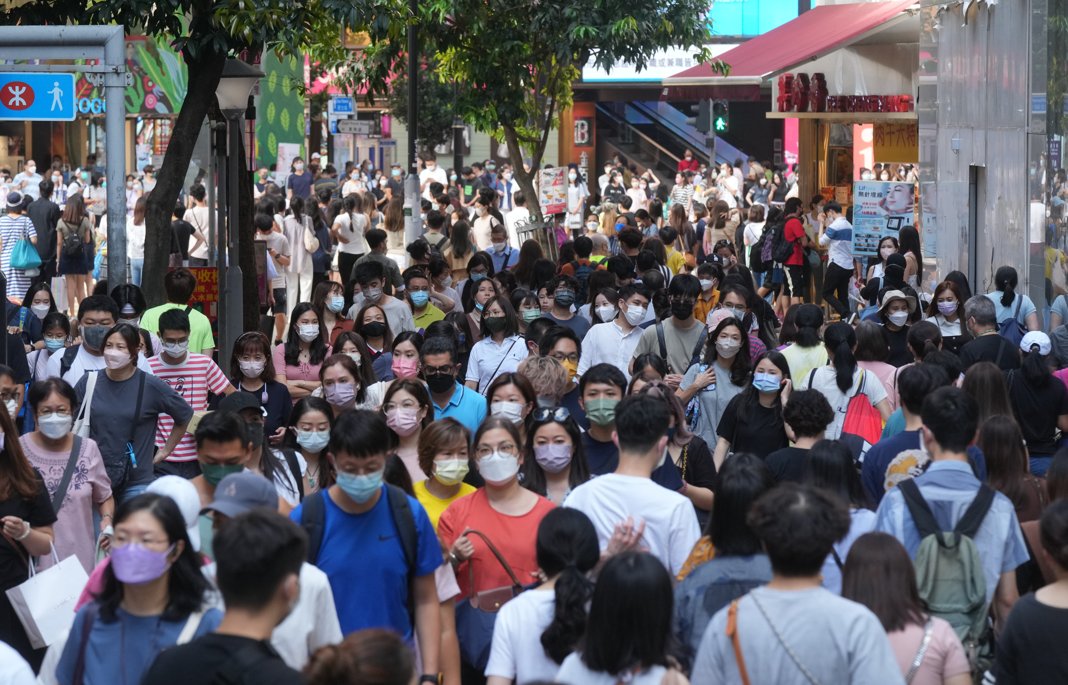 Crowds in Causeway Bay on August 7 last year. A number of economists have made it clear they feel the universal distribution of consumption vouchers is no longer necessary. Photo: Sam Tsang