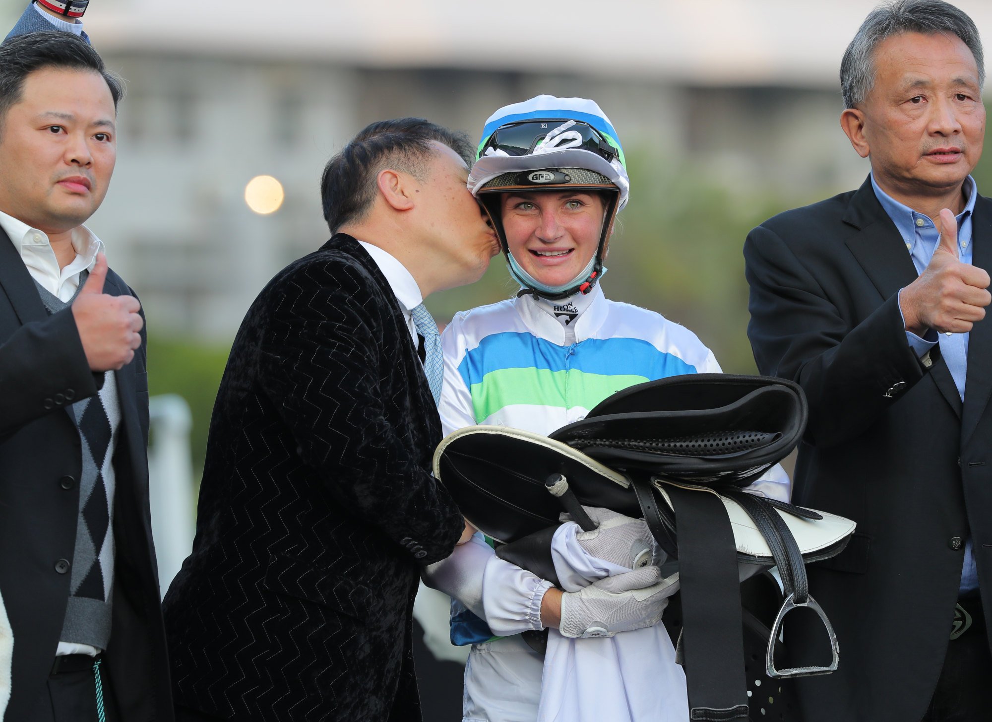 Trainer Ricky Yiu kisses jockey Jamie Kah as they celebrate Voyage Bubble’s Classic Mile win.