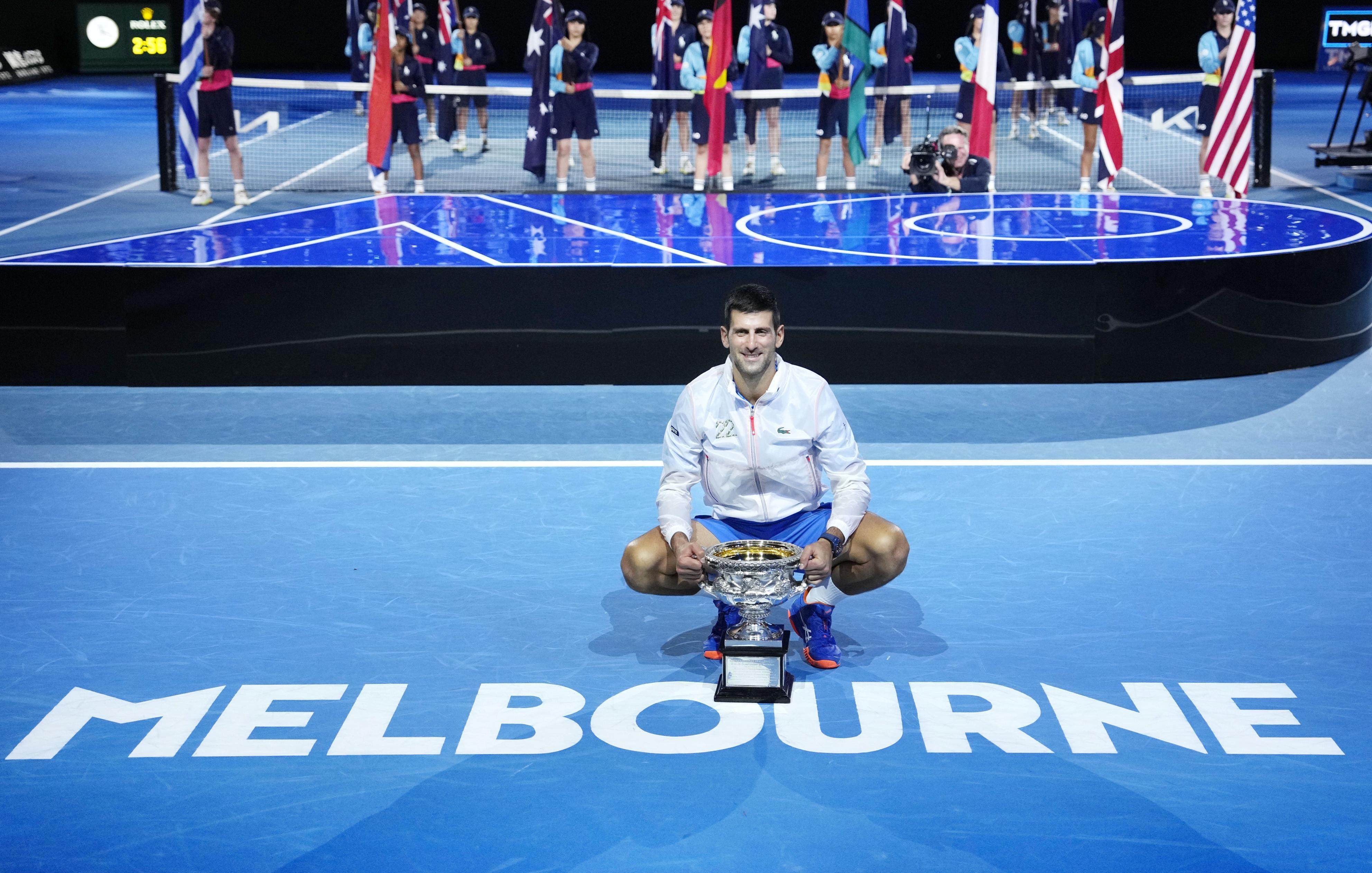 Novak Djokovic poses for pictures after claiming his 10th title at the Australian Open. Photo: Kyodo