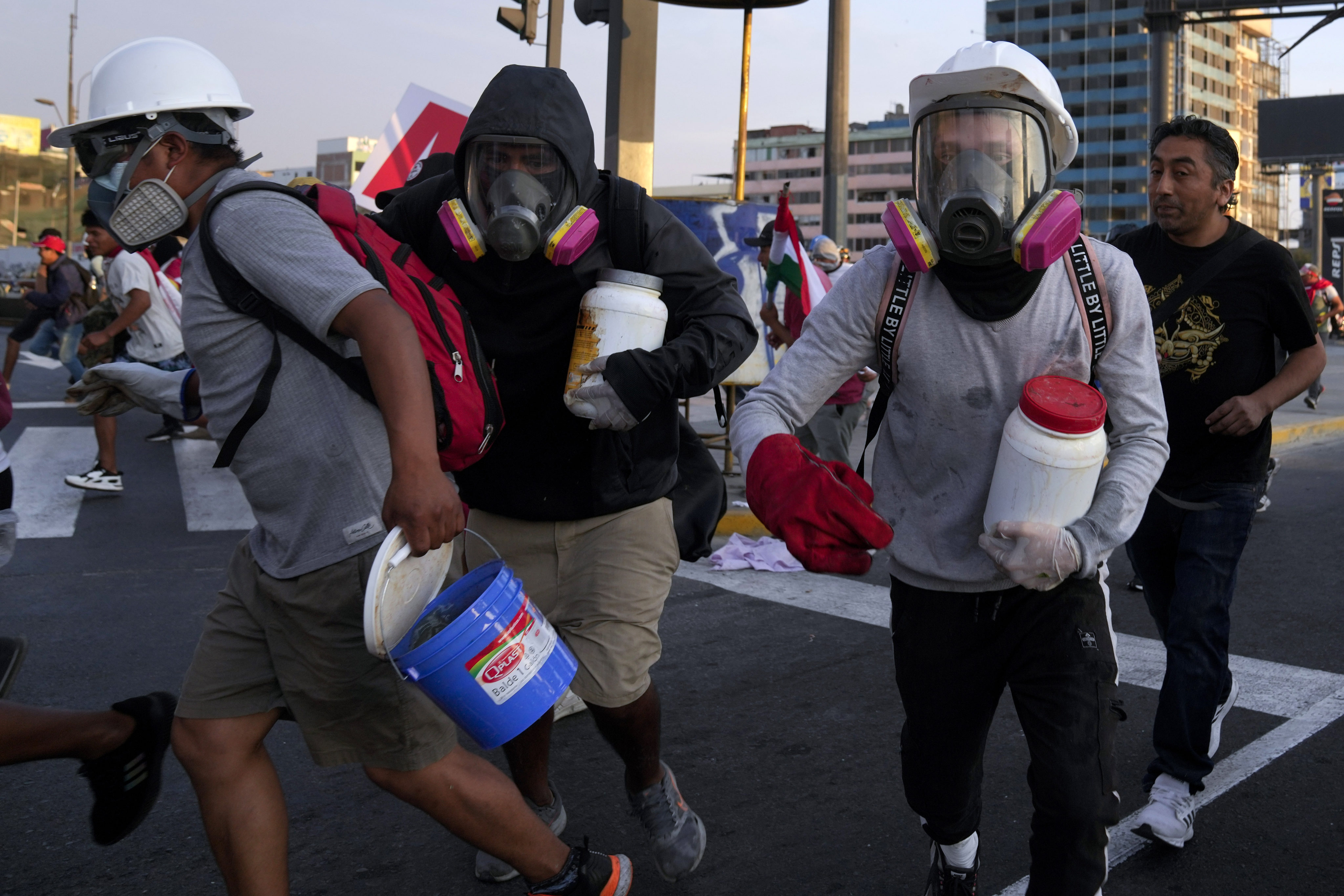 So-called ‘deactivators’ carry large plastic bottles filled with a mixture of water, baking soda and vinegar. Photo: AP