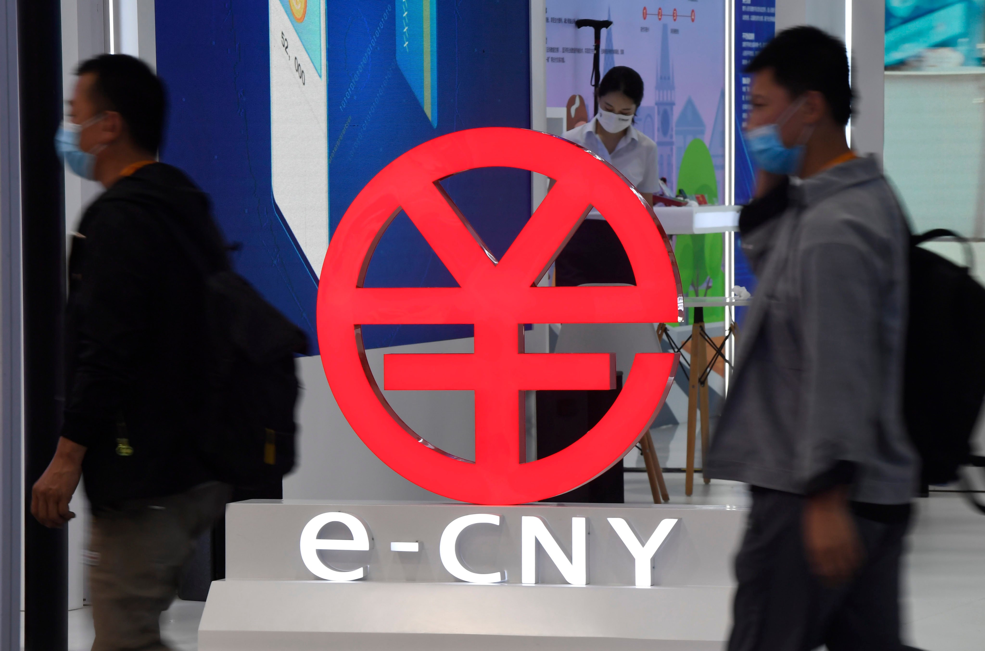 People walk past a digital yuan (e-CNY) sign during the 2021 China International Fair for Trade in Services (CIFTIS) in Beijing on September 5. Much of the CBDC dynamism is in Asia, and the principal focus is on China. Photo: Xinhua