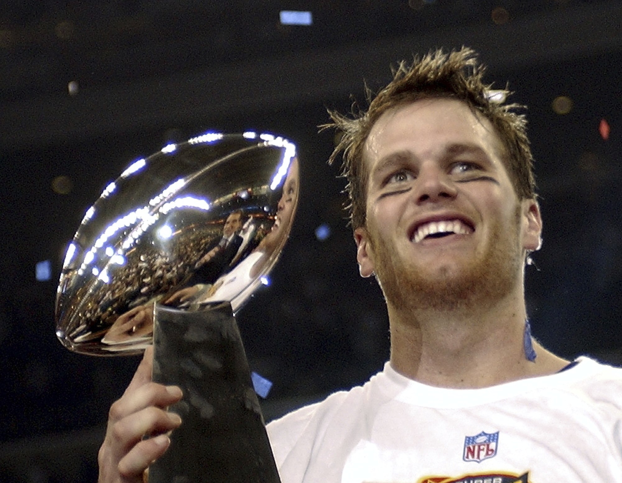 Tom Brady holds the Vince Lombardi Trophy after leading the New England Patriots to victory in the 2004 Super Bowl. Photo: AP