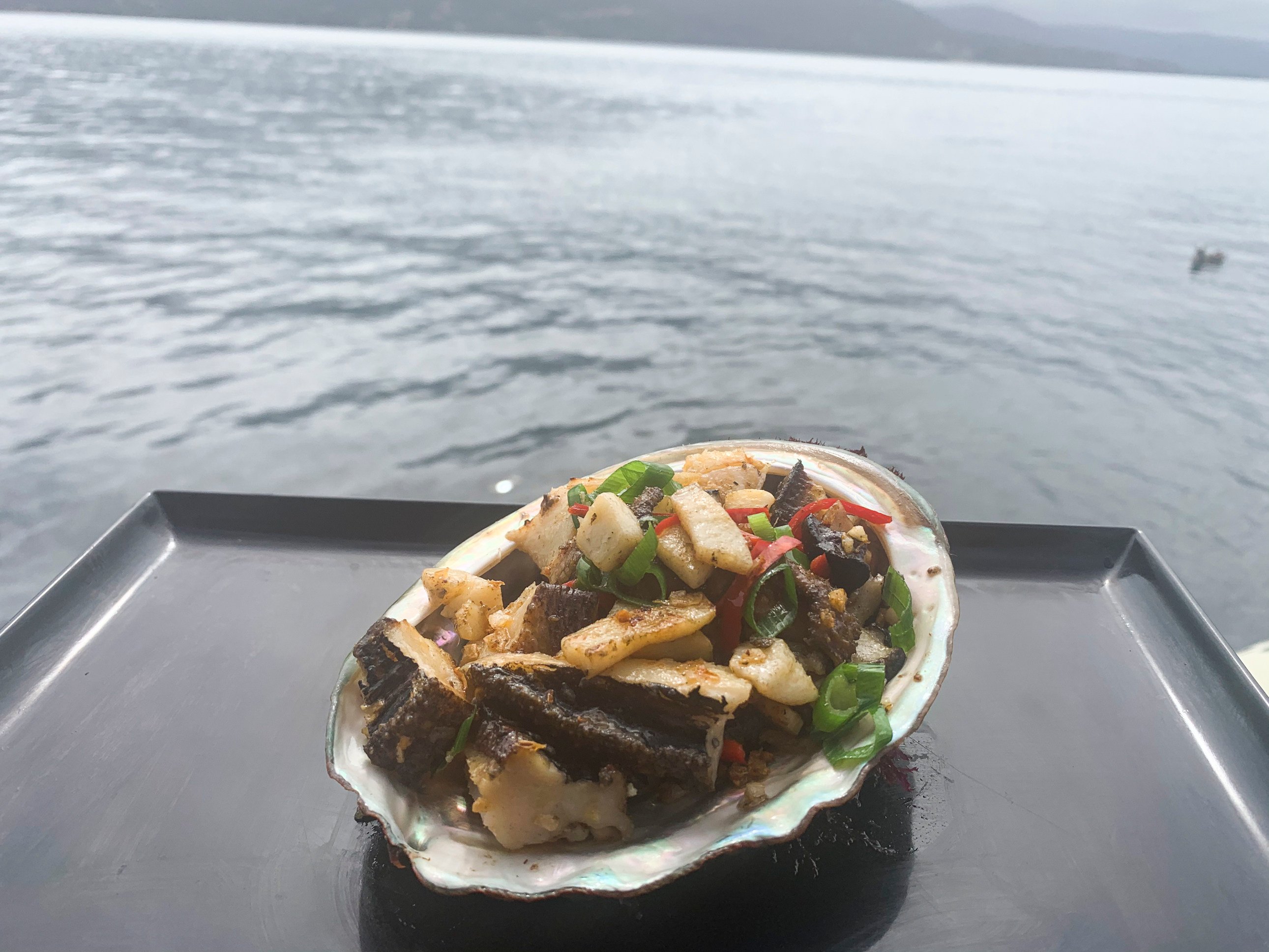 Freshly prepared abalone served in the shell, taken near Bruny Island,  Tasmania, during Pennicott Wilderness Journeys’ “Tasmanian Seafood Seduction” trip. Photo: Chris Dwyer