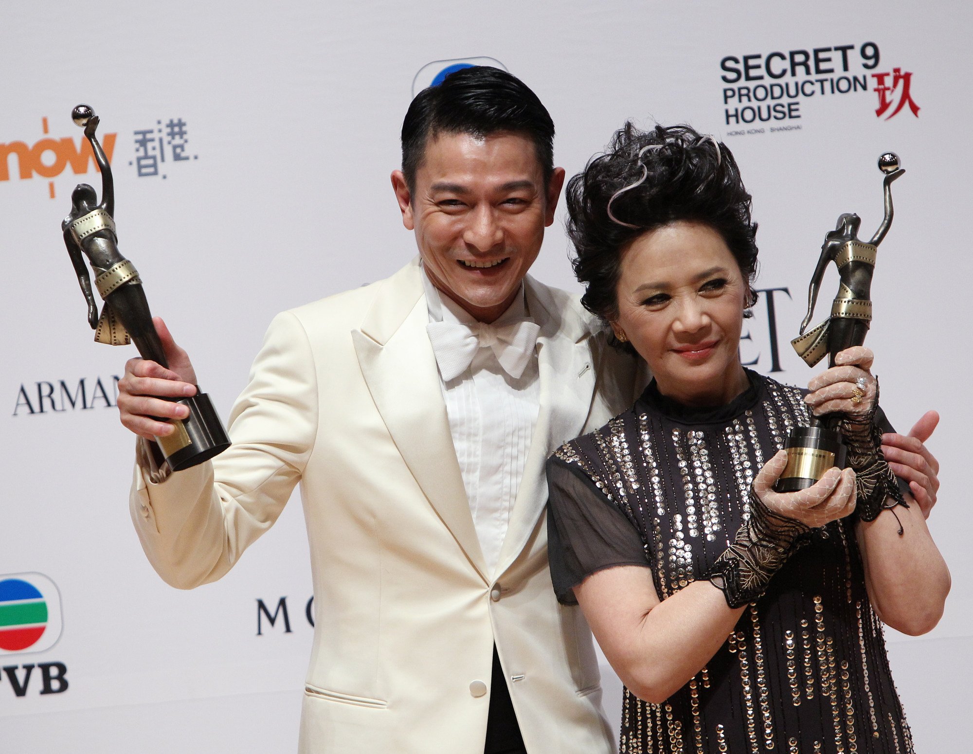 Andy Lau and Deanie Ip celebrate after winning the award for best actor and...