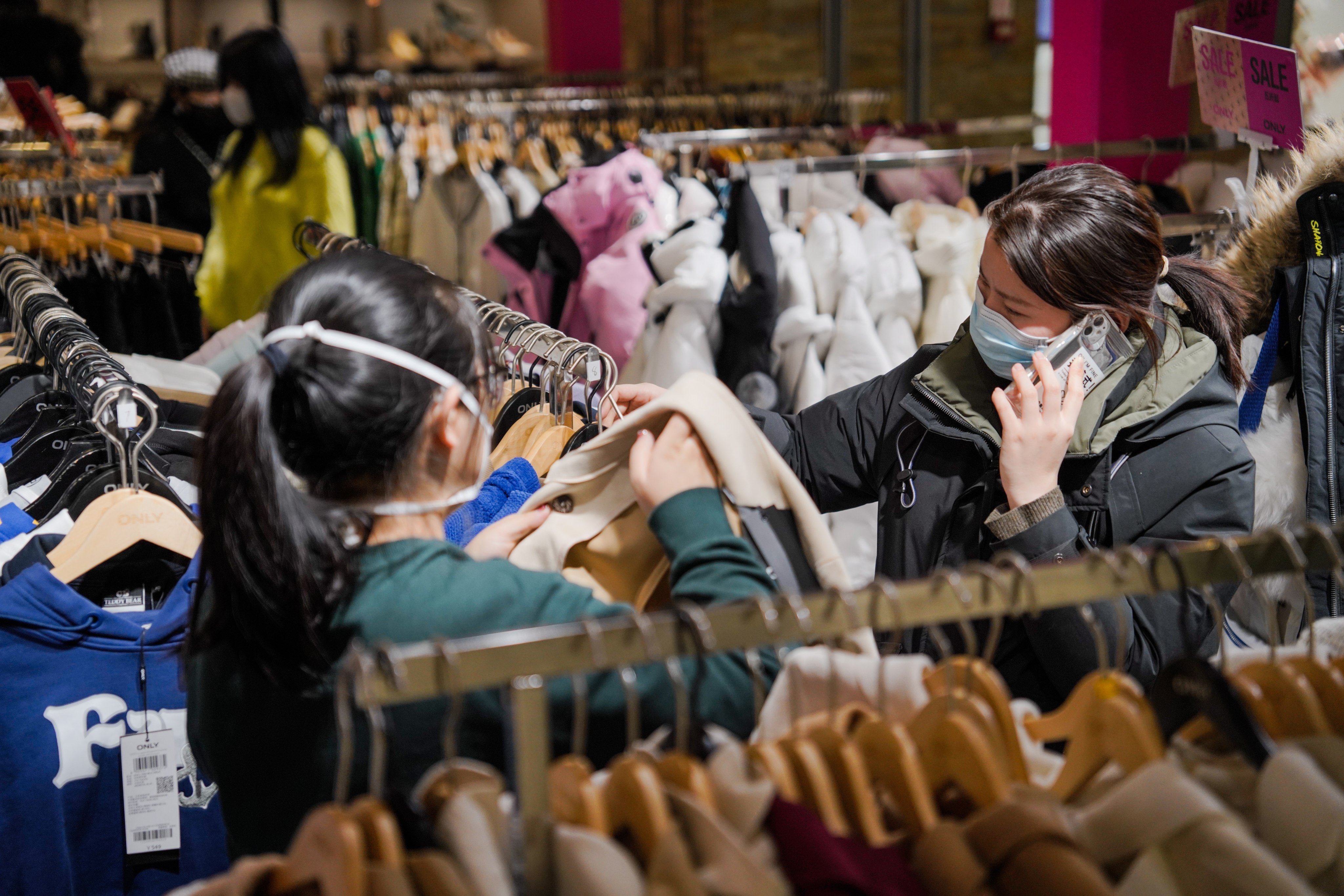People choose clothes at Joy City shopping centre in Beijing on January 31. There are fears the increase in household savings in China reflects economic uncertainty rather than pent-up demand. Photo: EPA-EFE