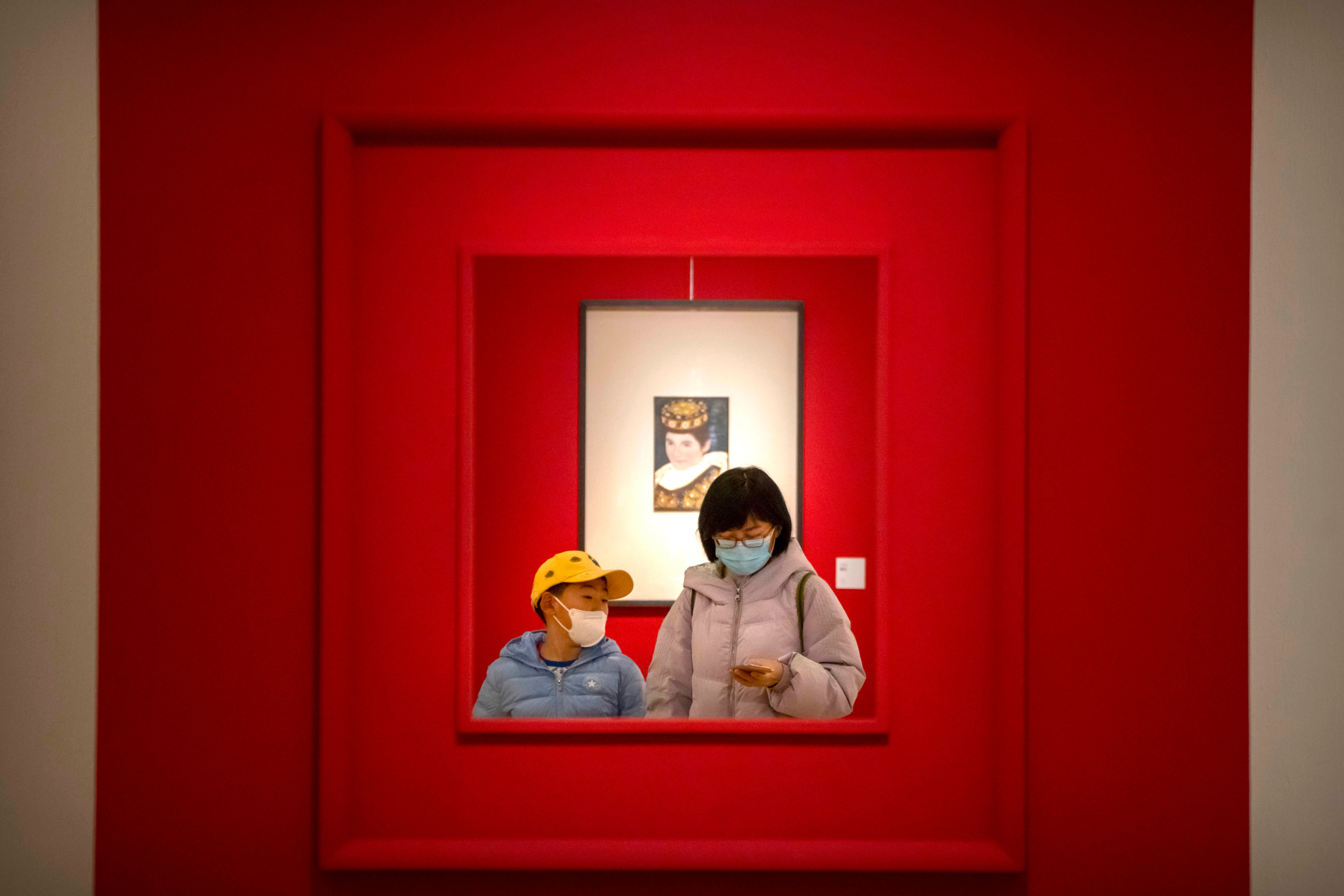 A woman and child walk through a gallery at the National Art Museum of China in Beijing on February 1. Three years of Covid-19 have exacerbated the urban-rural divide and worsened income inequality. Photo: AP