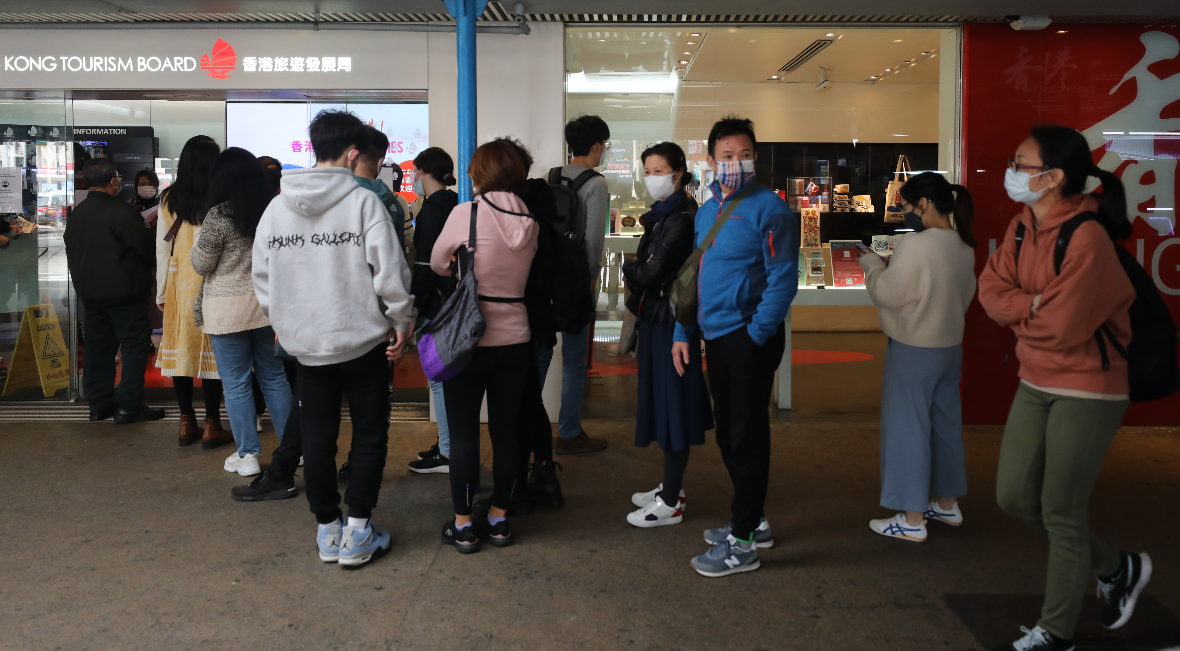 The Hong Kong Tourism Board Visitor Centre in Tsim Sha Tsui is busy as people queue up to claim vouchers. Photo: Xiaomei Chen