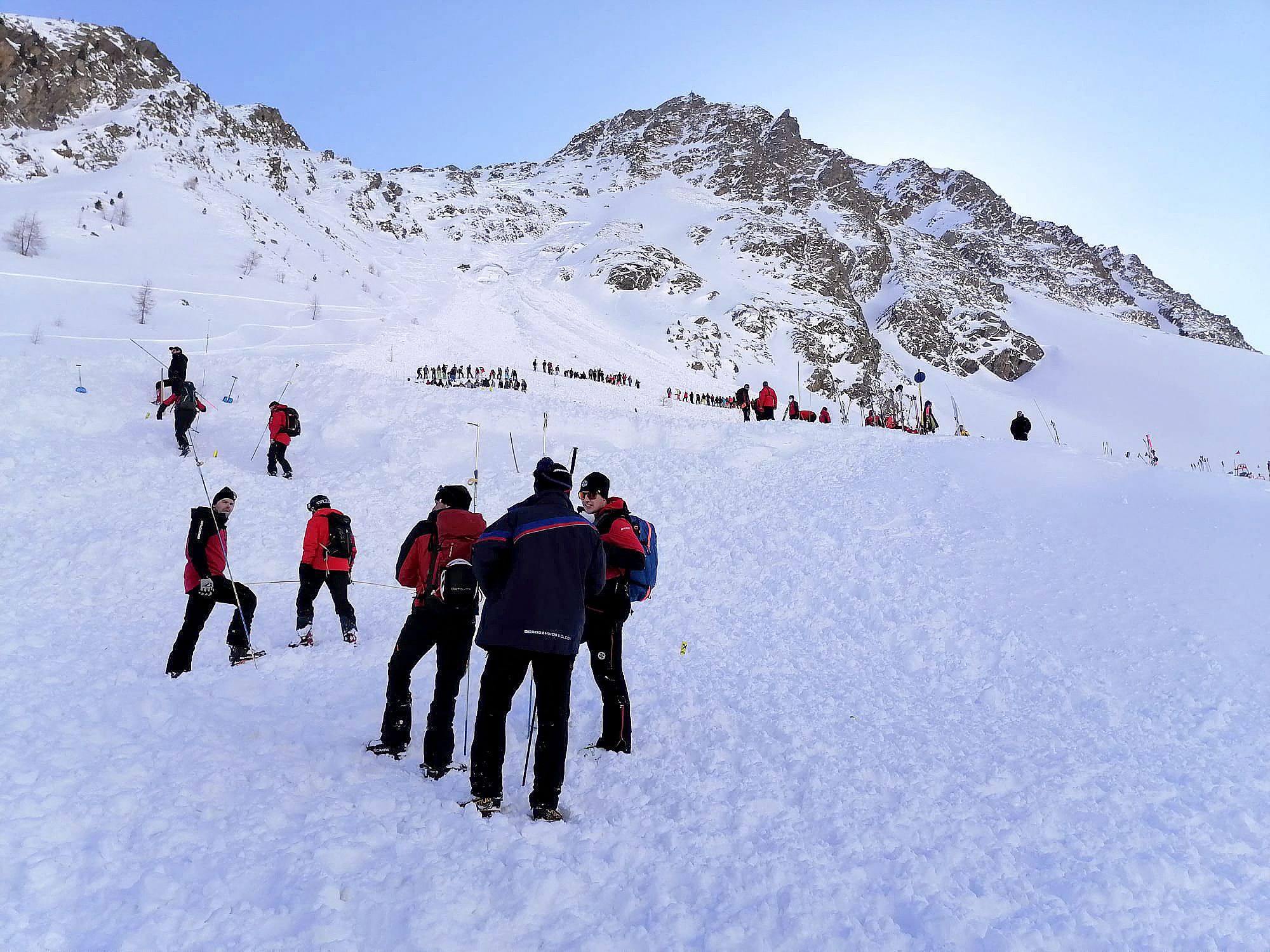 Rescuers stand at the Rettenbach glacier near Soelden,  Austria in February 2022 after an avalanche. A series of avalanches in Austria has left three people dead since Friday.  Photo: APA / AFP