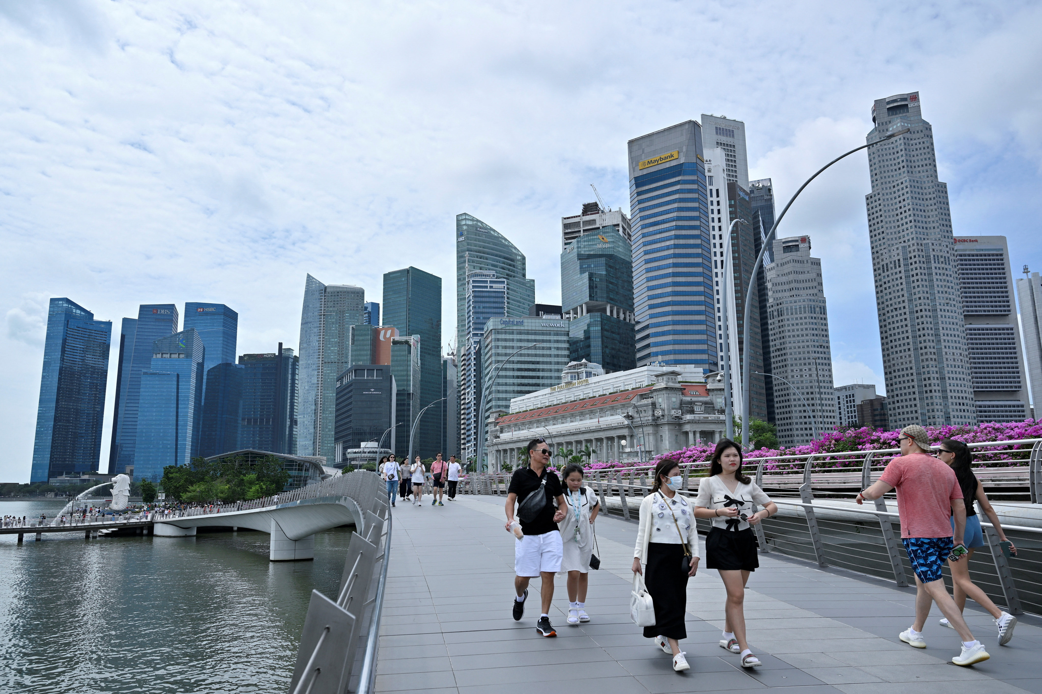 People walk along the waterfront in Singapore last month. Photo: Reuters