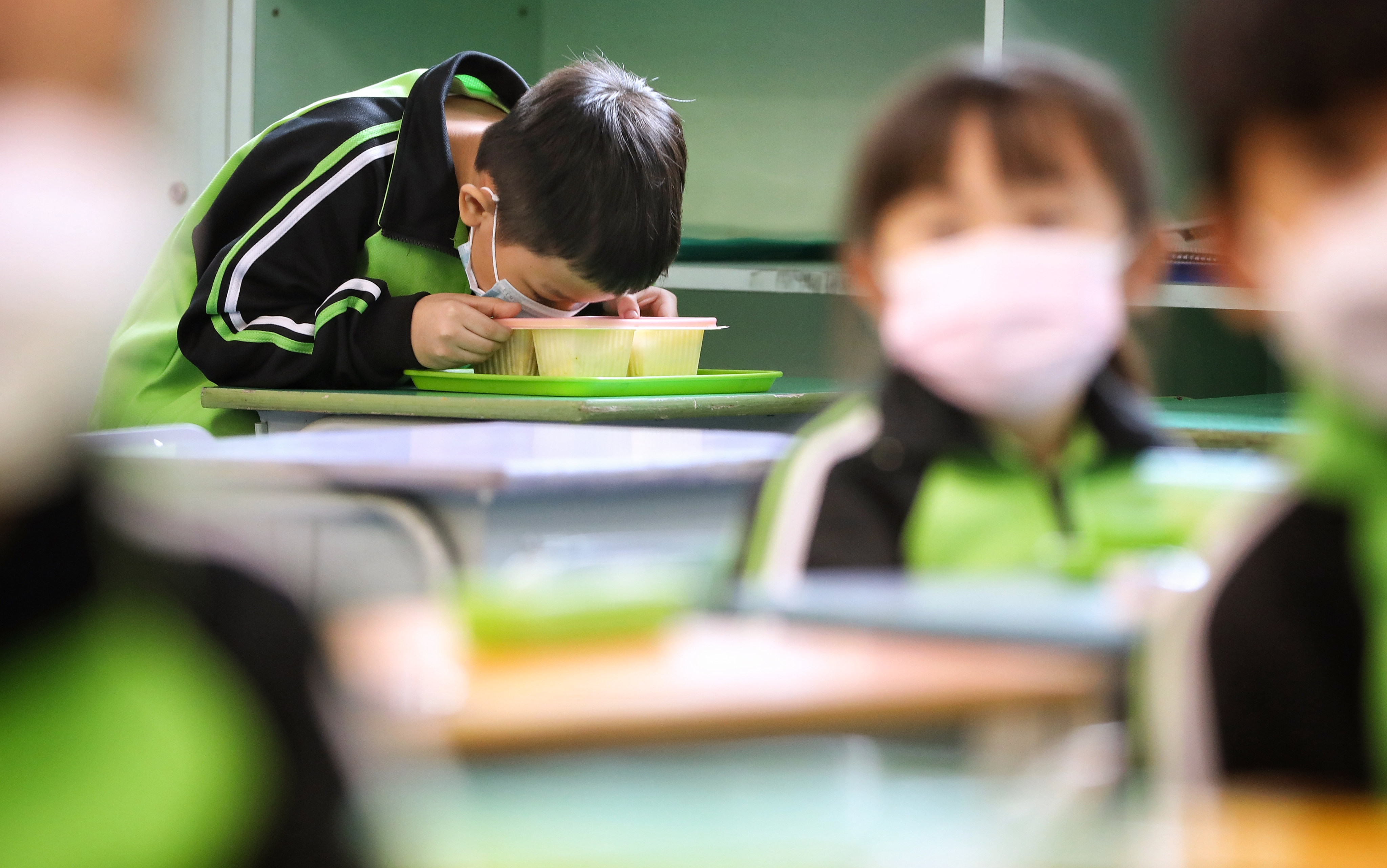 Pupils eat lunch at their desks after returning to full-day in-person learning on December 1 last year at a school in Tsing Yi. Photo: Elson Li