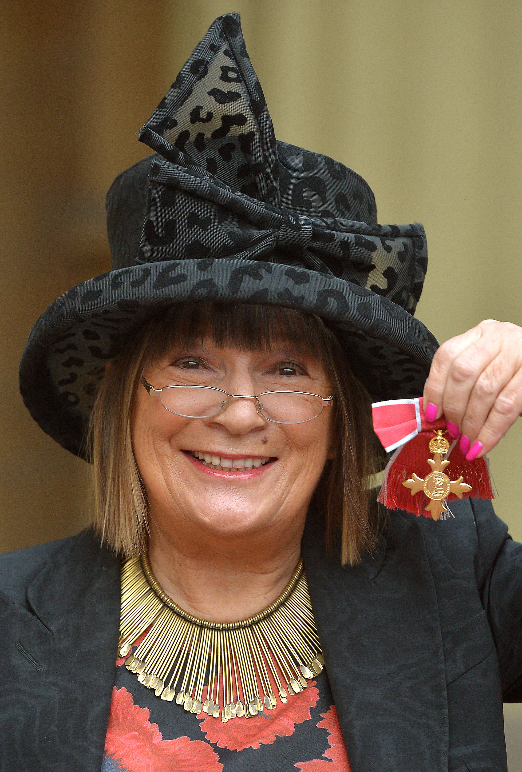 British fashion journalist Hilary Alexander  holds her Officer of the Order of the British Empire (OBE) medal, after it was presented to her by Queen Elizabeth II, during the Investiture ceremony at Buckingham Palace in central London on November 28, 2013.  Photo: AFP