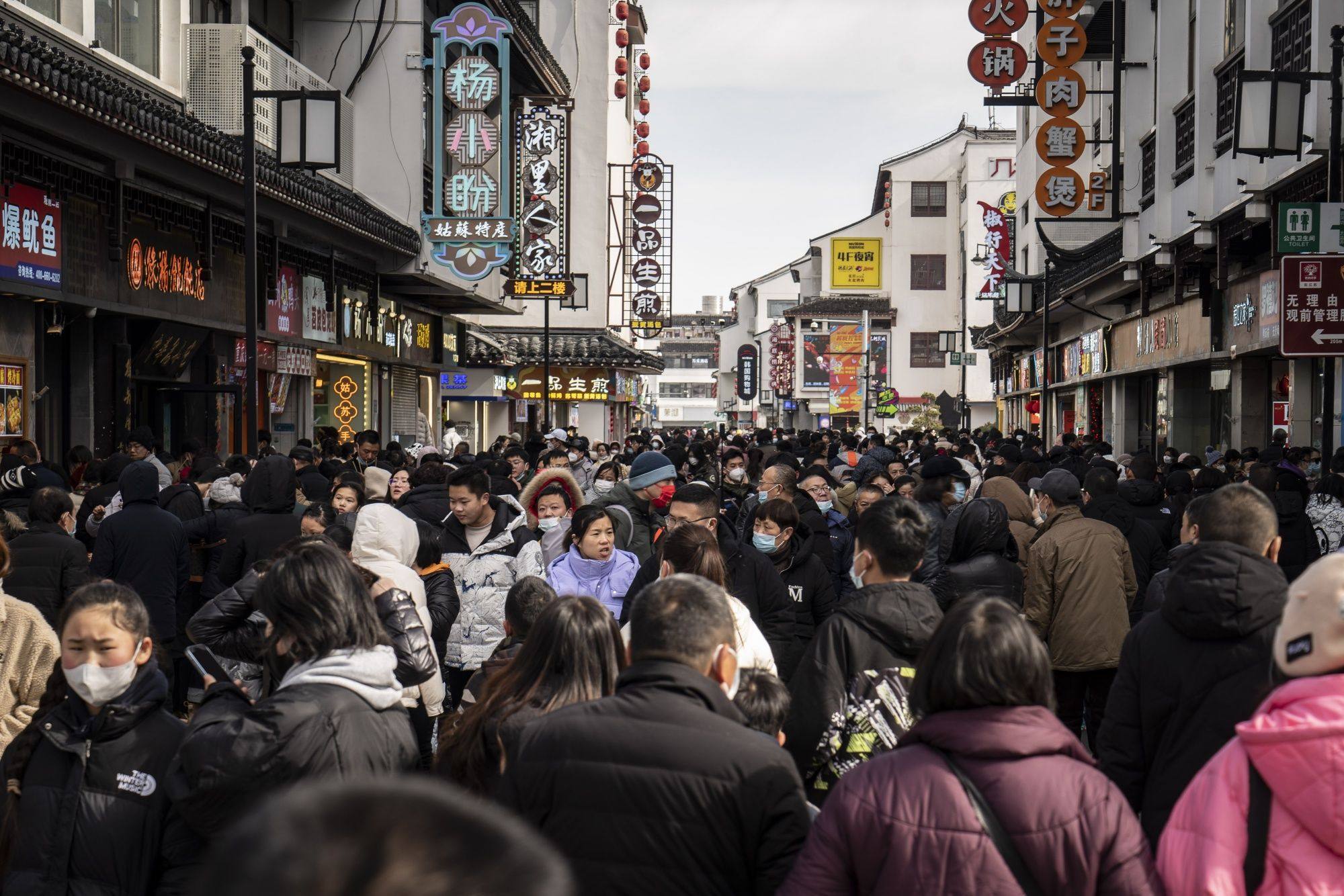 Shoppers in the Guanqian Street shopping area in Suzhou, Jiangsu province, on January 25. China’s Lunar New Year travel and box office figures showed promising returns, adding to evidence that the country’s economic recovery could be around for the long haul. Photo: Bloomberg