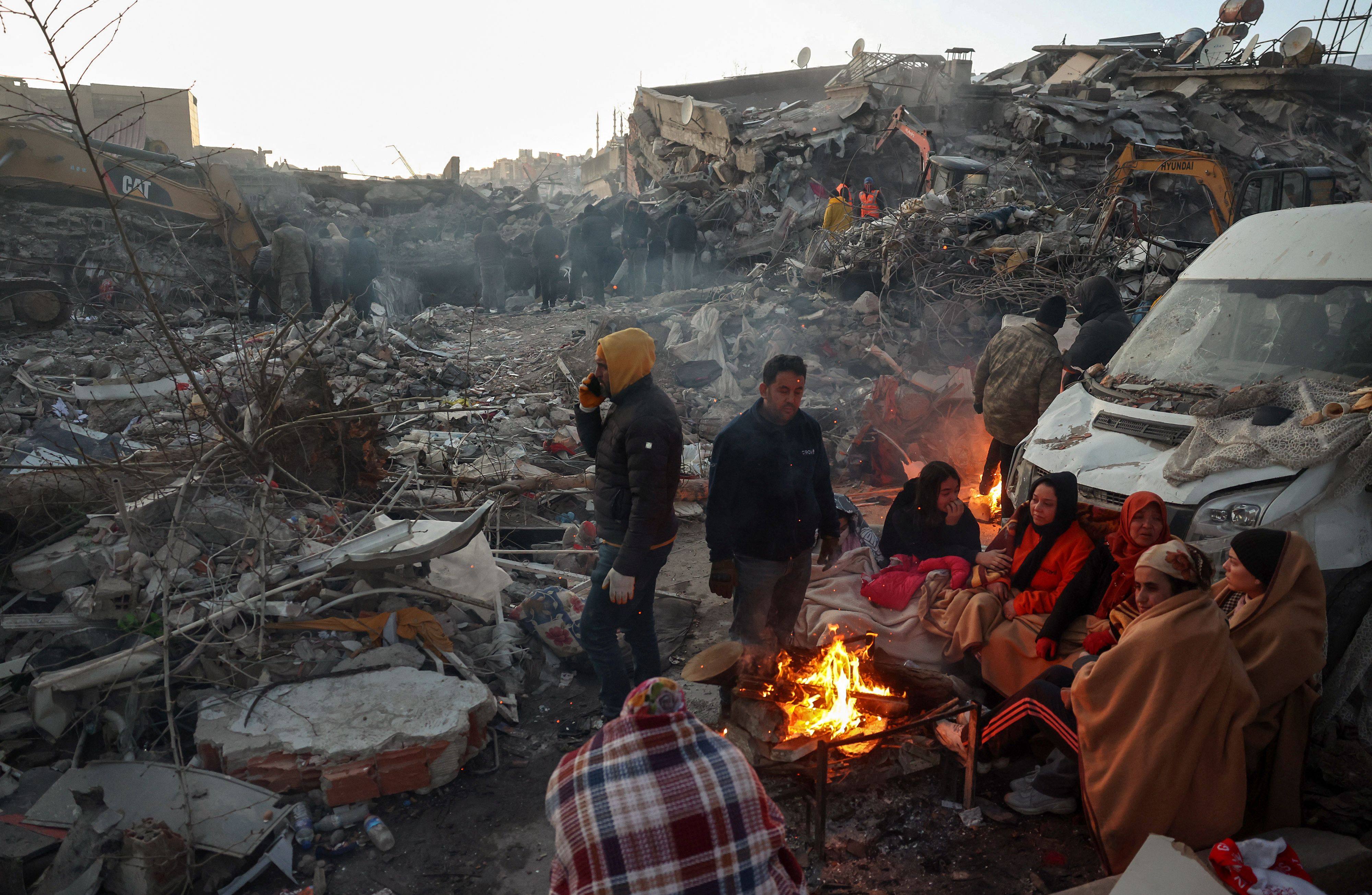 Earthquake survivors gather round a bonfire in Turkey. Might the international response to the massive tragedy improve relations between governments? Photo: AFP