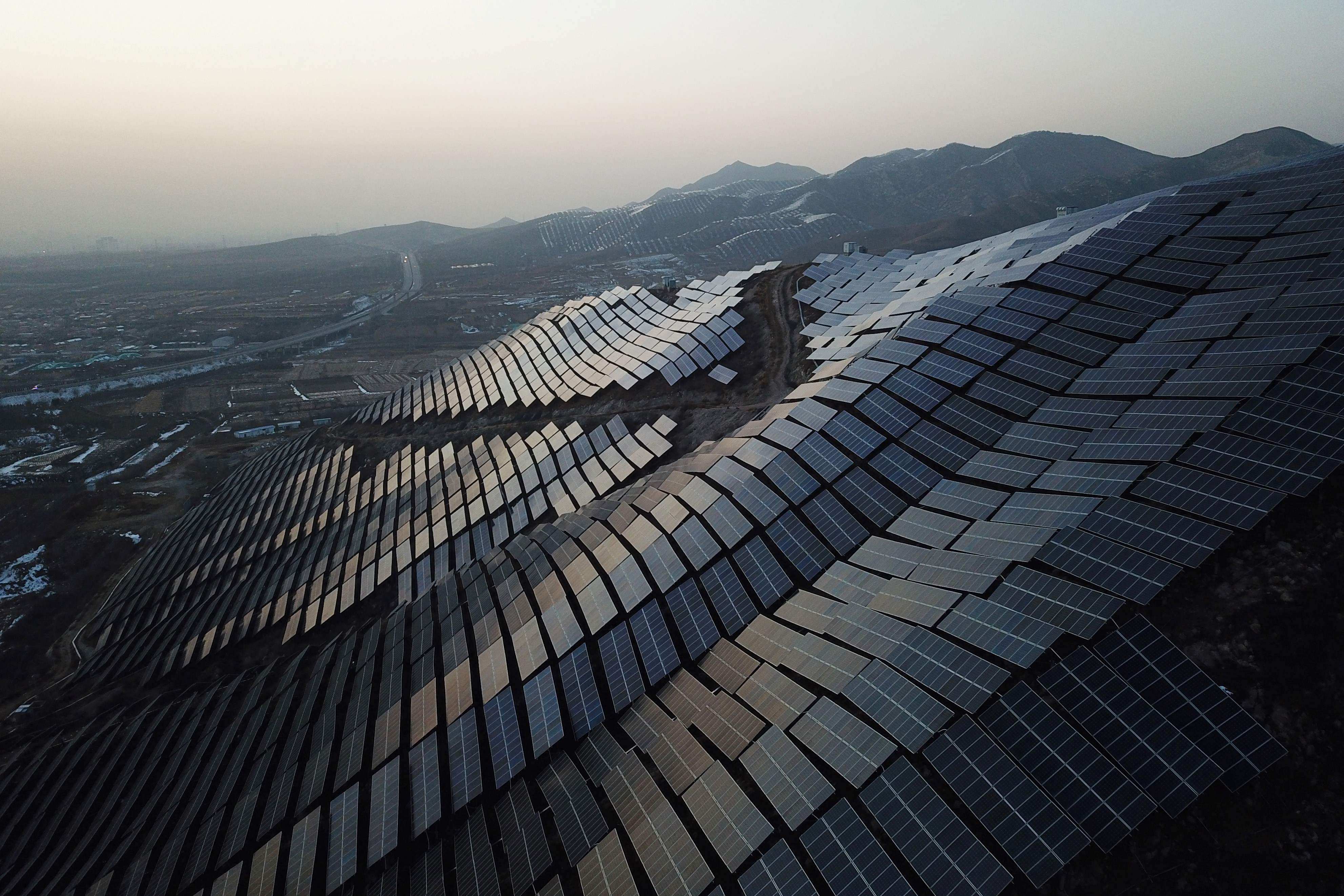 Solar panels are seen on hillsides at Xuanhua in Zhangjiakou, in China’s northern Hebei province, in November 2021. China accounted for 33 per cent of the world’s renewable electricity supply in 2021. Photo: AFP