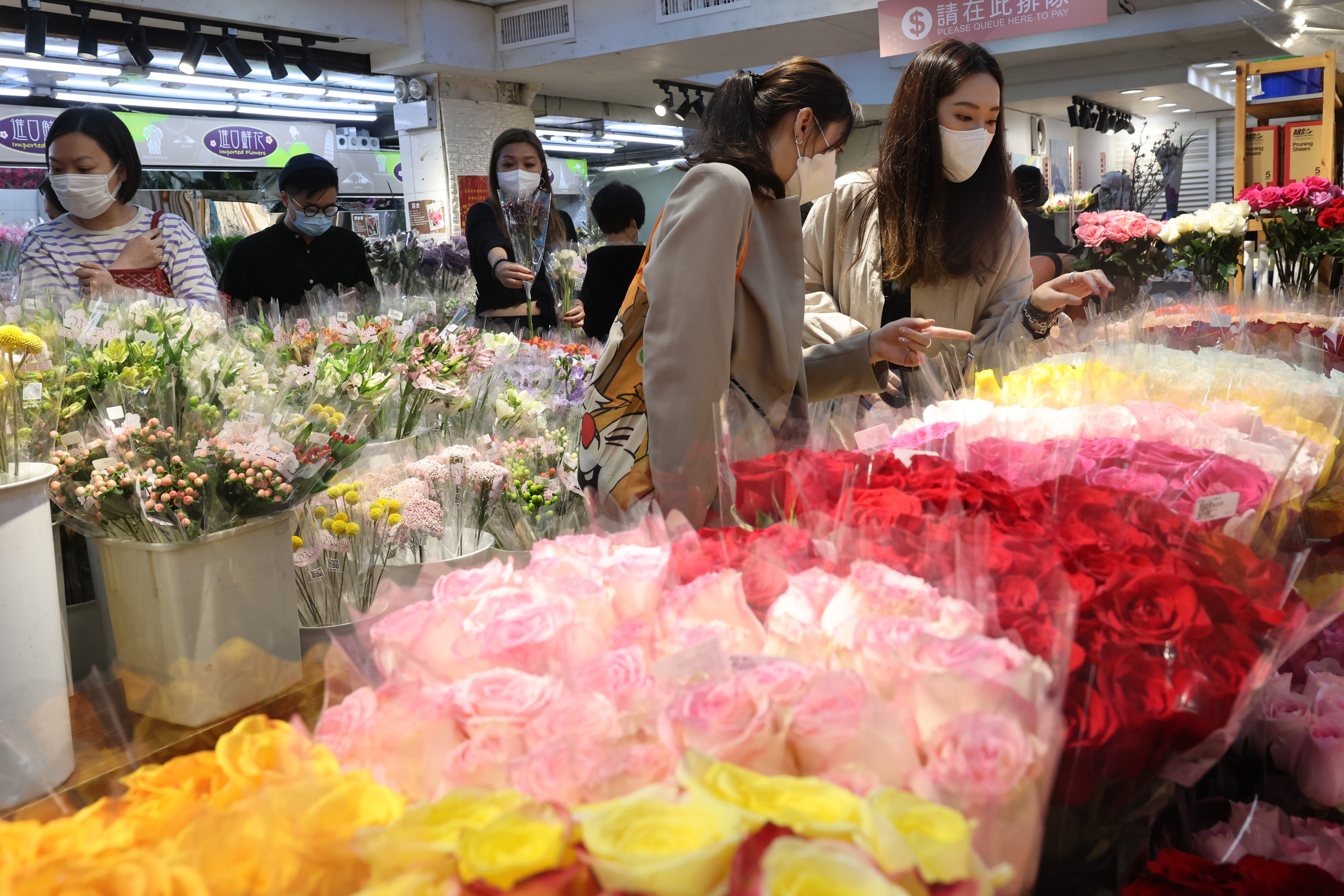 Customers check out the goods at the flower market in Mong Kok. Photo: Edmond So