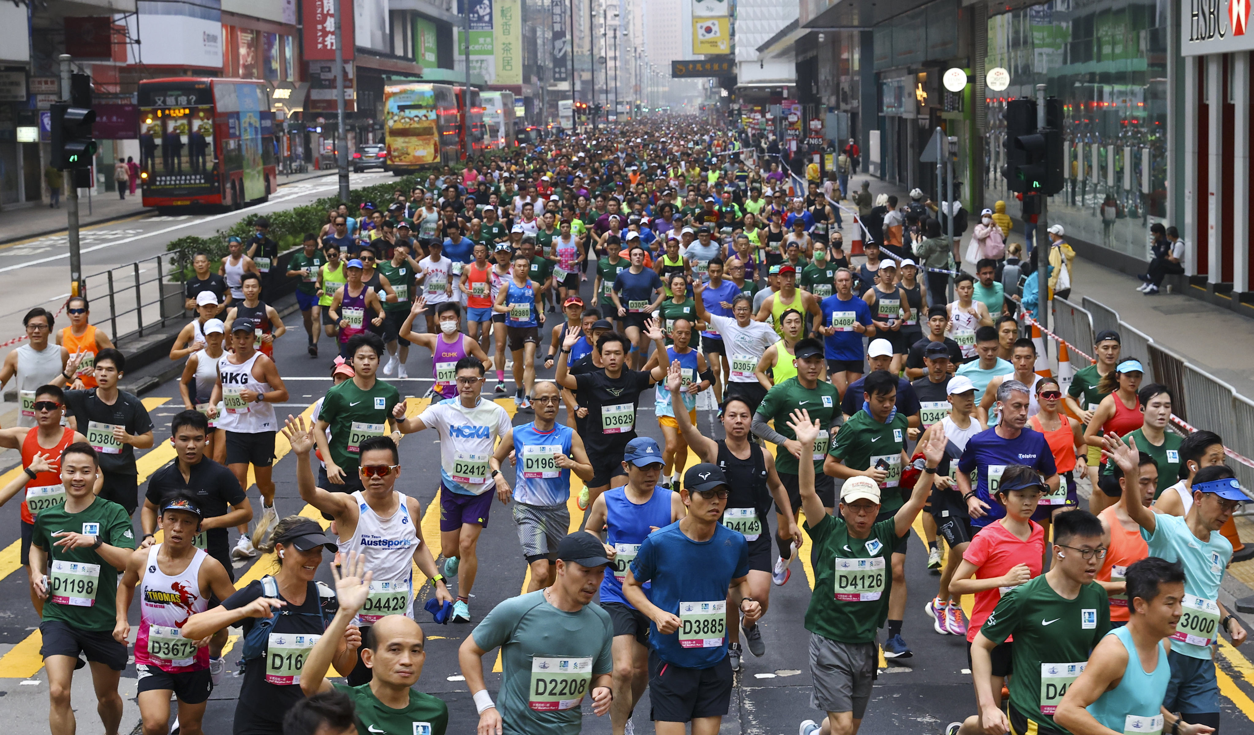 Runners head down Nathan Road in Mong Kok at the start of the 25th Standard Chartered Hong Kong Marathon. Photo: Dickson Lee
