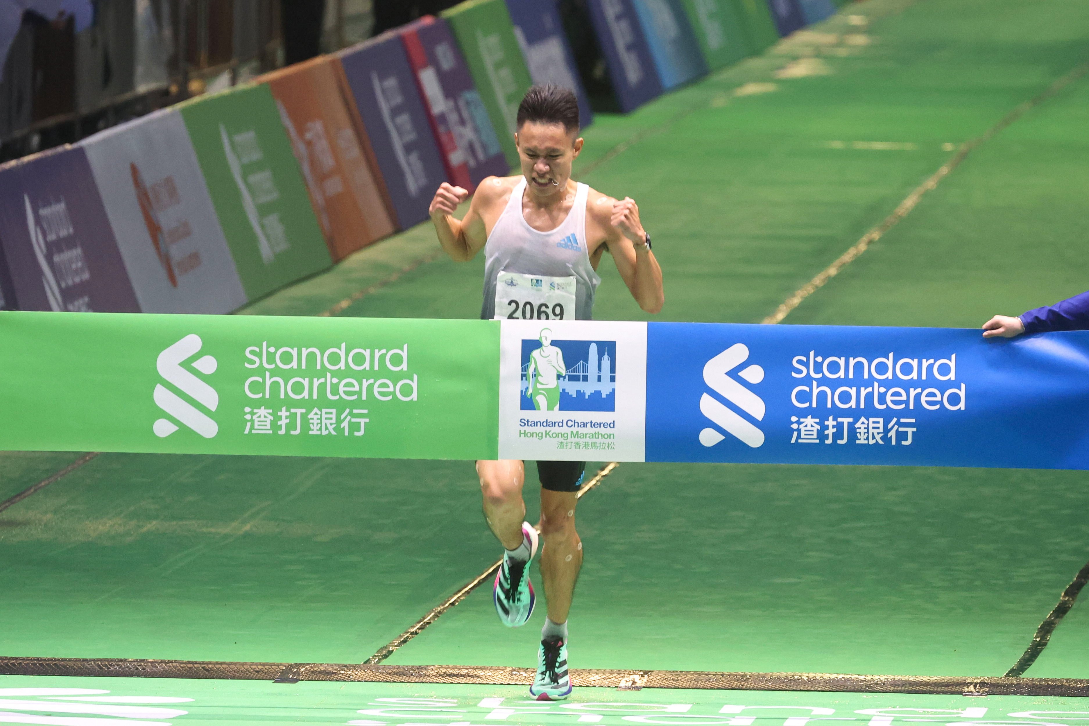 Men’s half-marathon champion Eric Wong crosses the finish line in Victoria Park. Photo: Yik Yeung-man