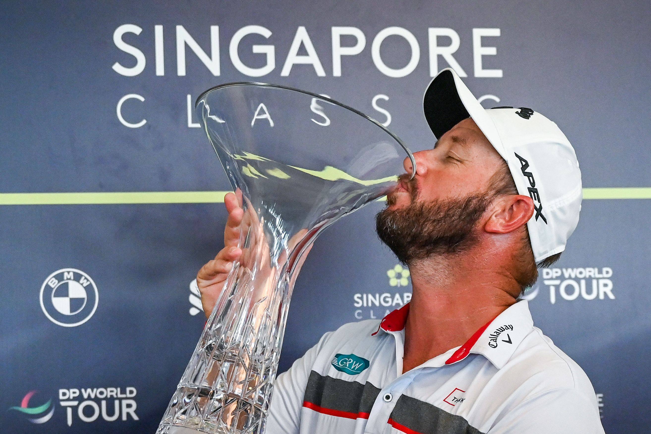 Ockie Strydom poses with the trophy after winning the DP World Tour Singapore Classic. Photo: AFP