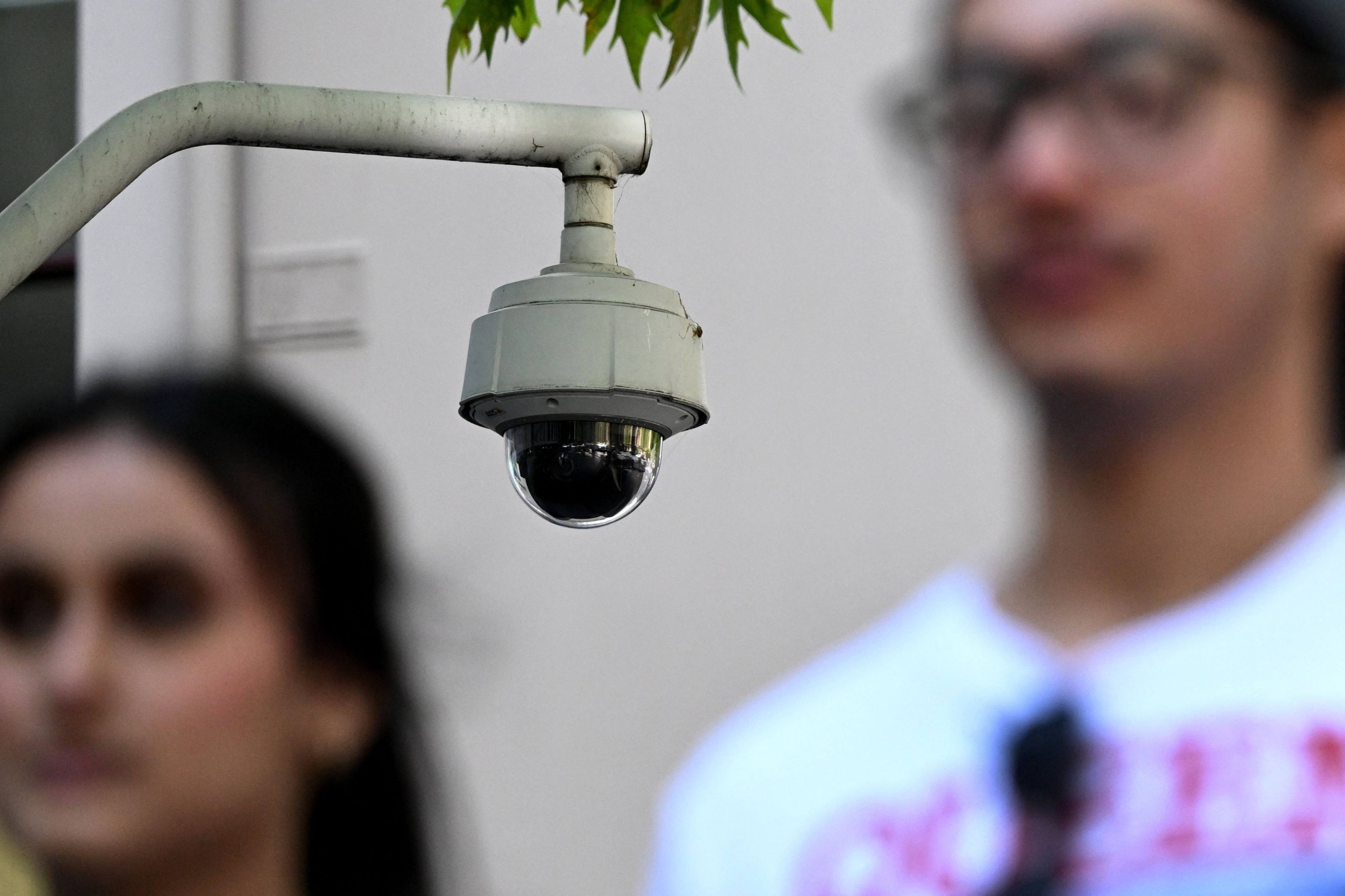 People walk past a security camera in Melbourne. Photo: AFP 