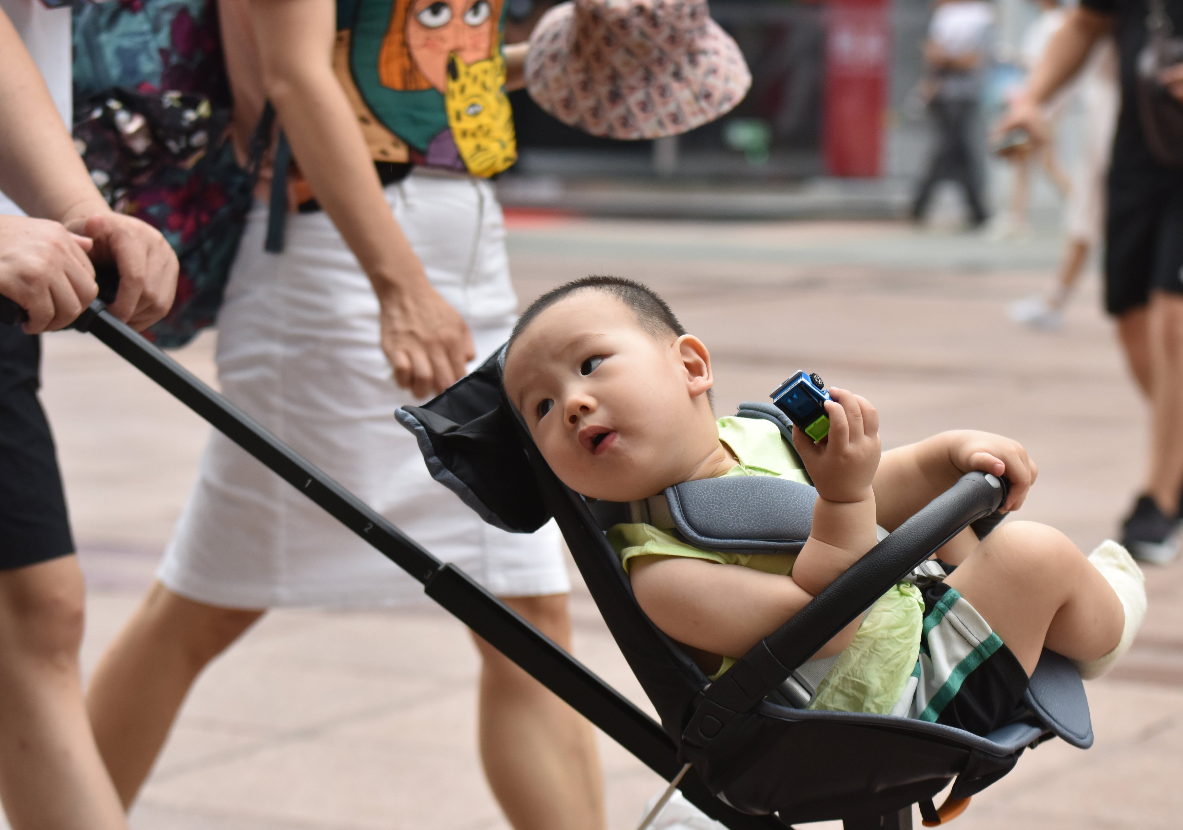 A parent pushes a child in a pram in Beijing on July 21, 2021. Photo: Getty Images
