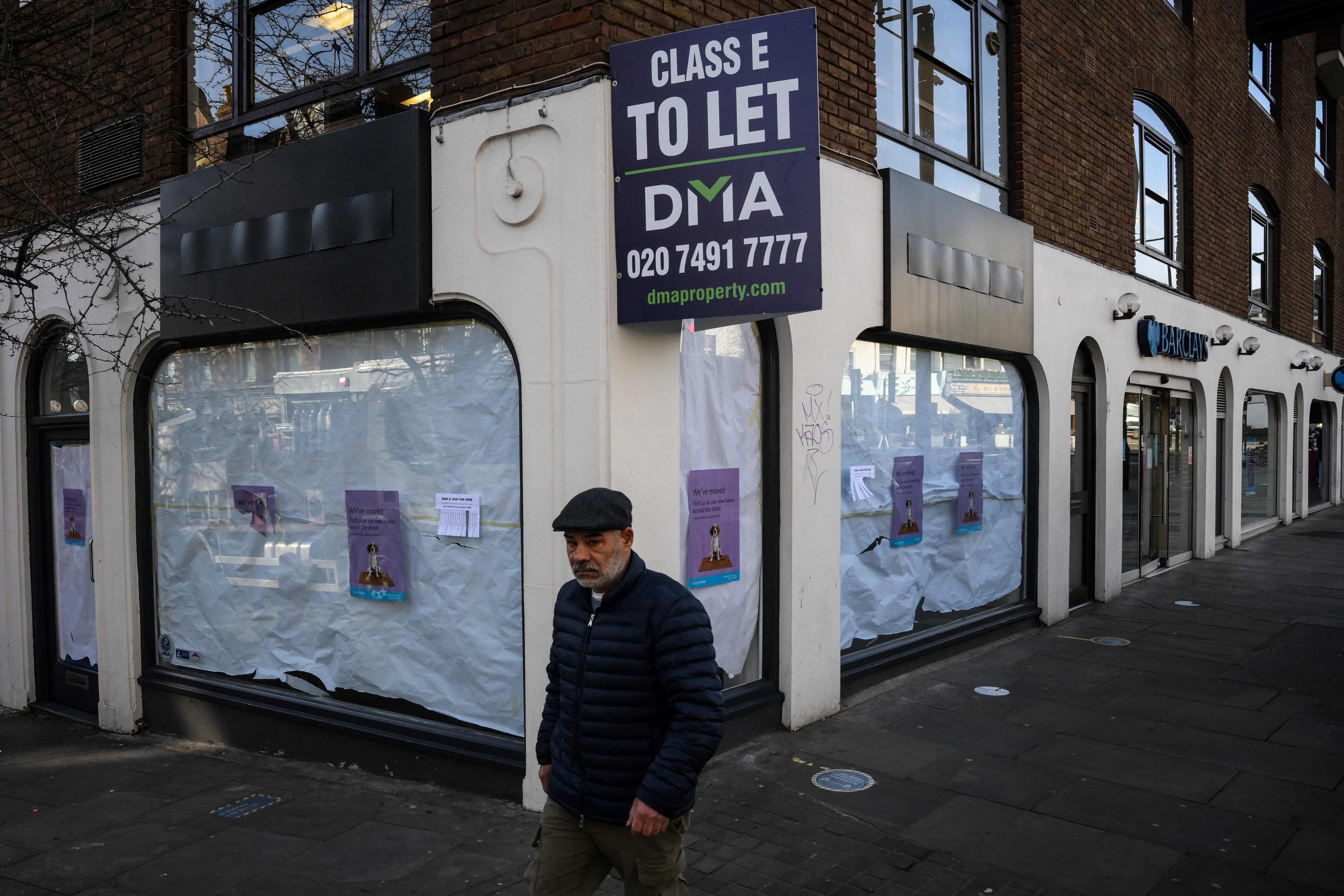 A pedestrian walks past a closed business in the Islington neighbourhood of London on February 10. Britain’s economy narrowly avoided recession, official data showed last week, but British officials warned it was “not out of the woods yet” over surging inflation. Photo: AFP