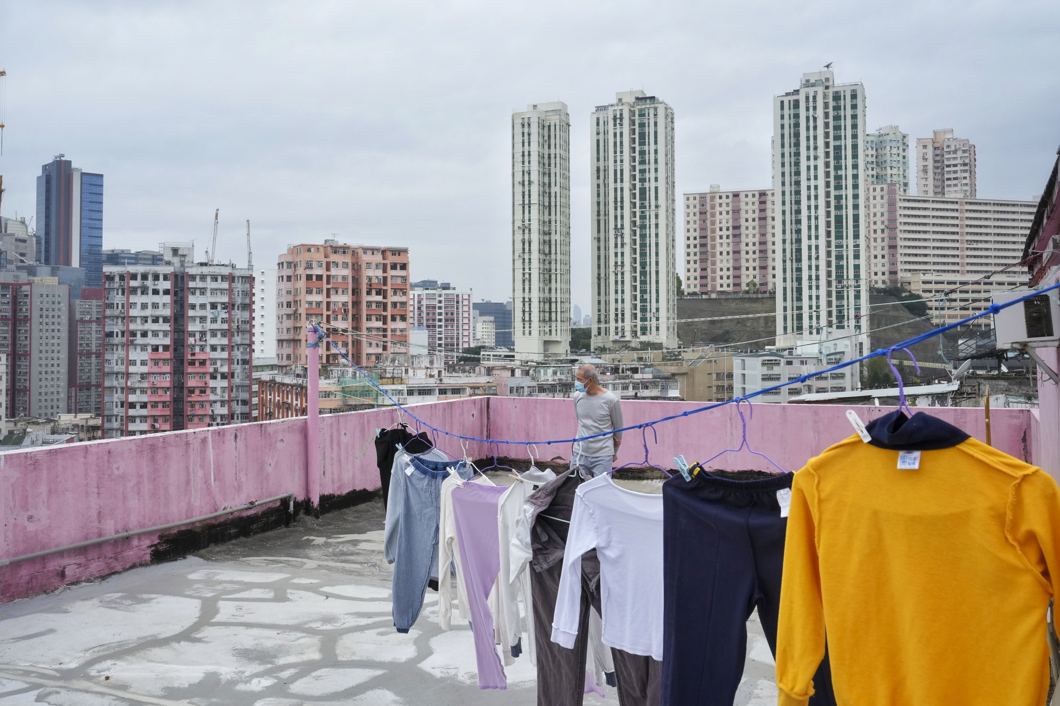 A man stands on the terrace of a building in Kwun Tong on February 5. The government has proposed to make legislative amendments to six ordinances related to to town planning, reclamation and roadworks. Photo: Elson Li