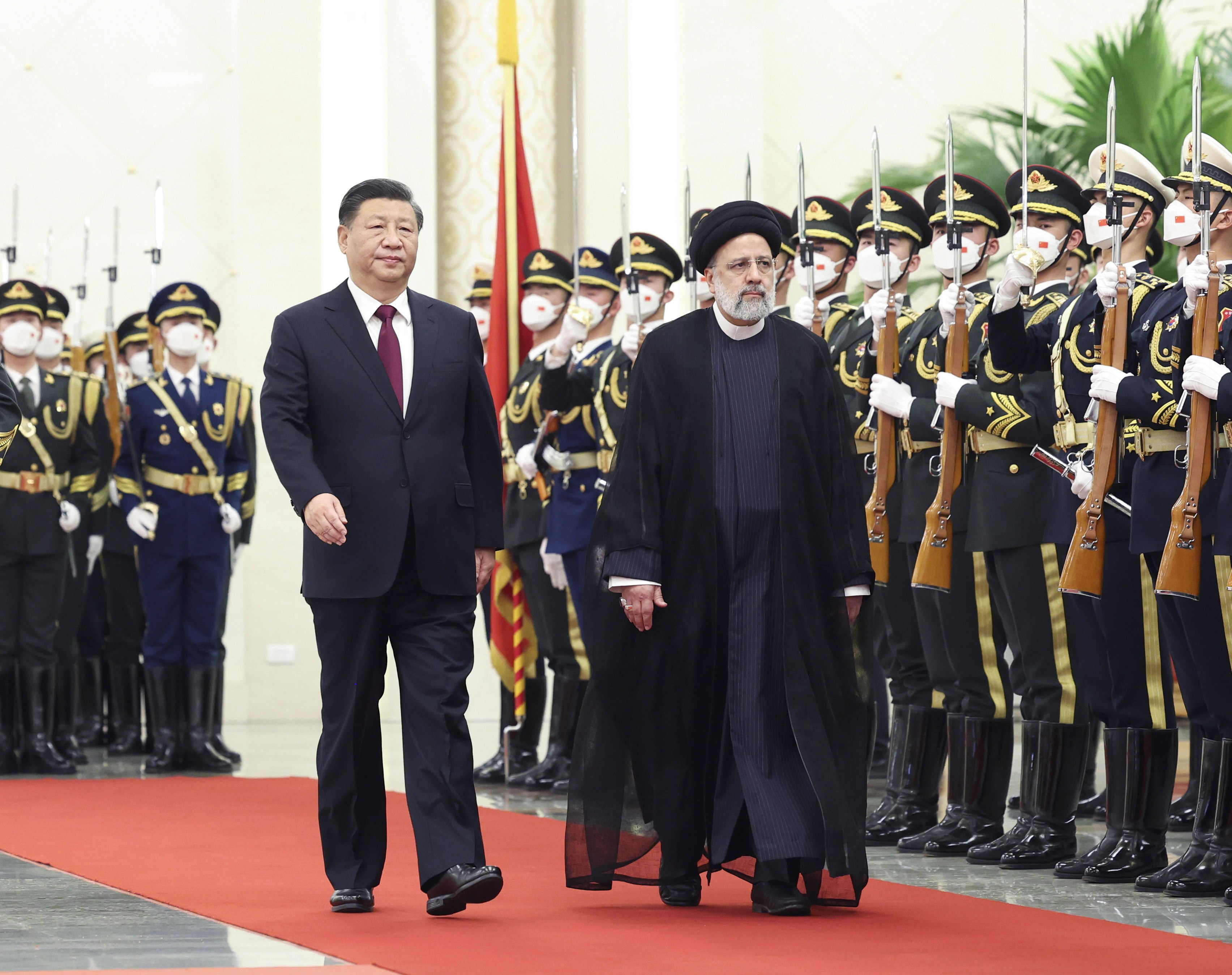 Chinese President Xi Jinping accompanies   Iranian President Ebrahim Raisi as he is given a guard of honour ahead of their talks in Beijing on Tuesday. Photo: EPA-EFE 