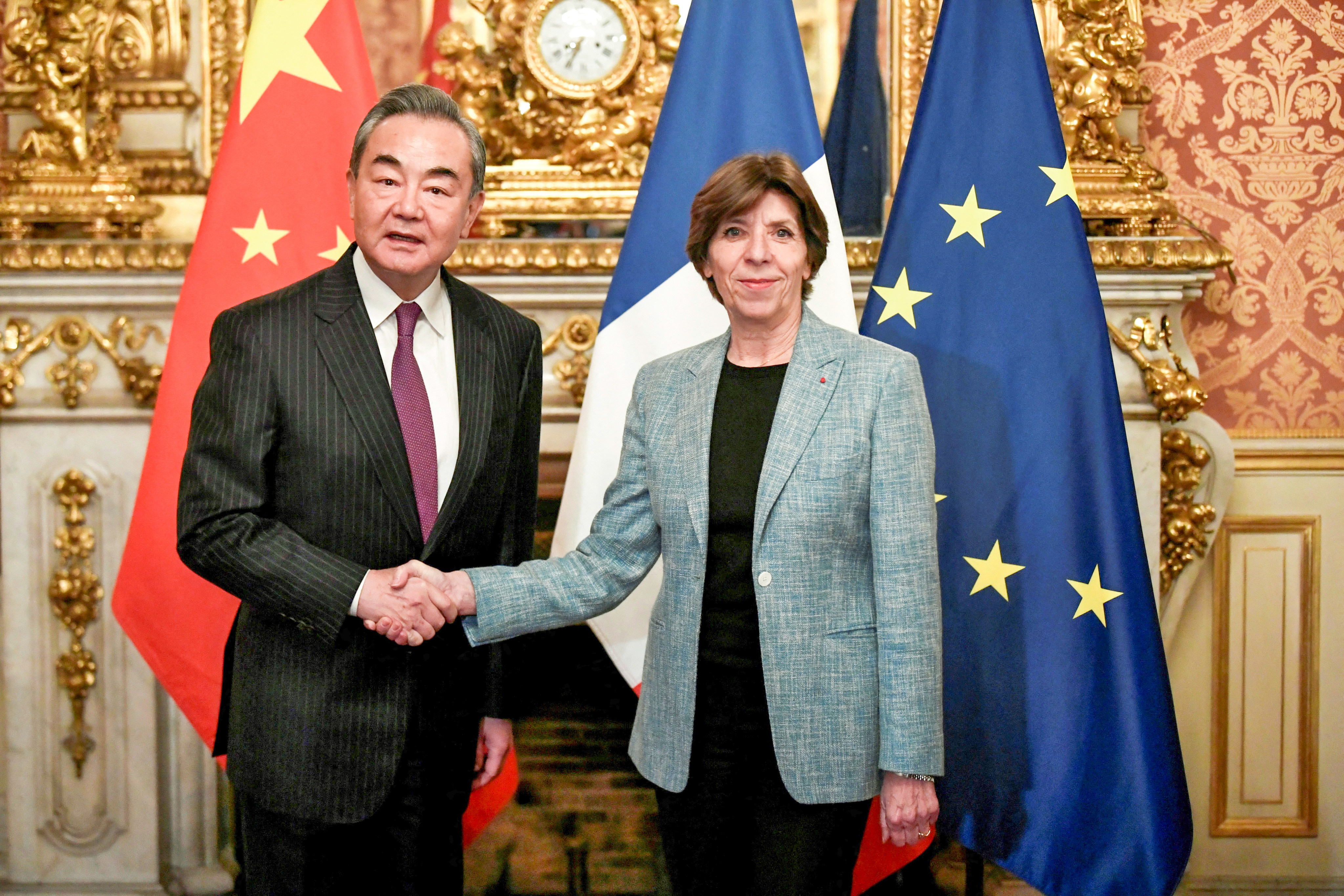 Wang Yi shakes hands with French Foreign Minister Catherine Colonna in Paris on Wednesday. Photo: Reuters