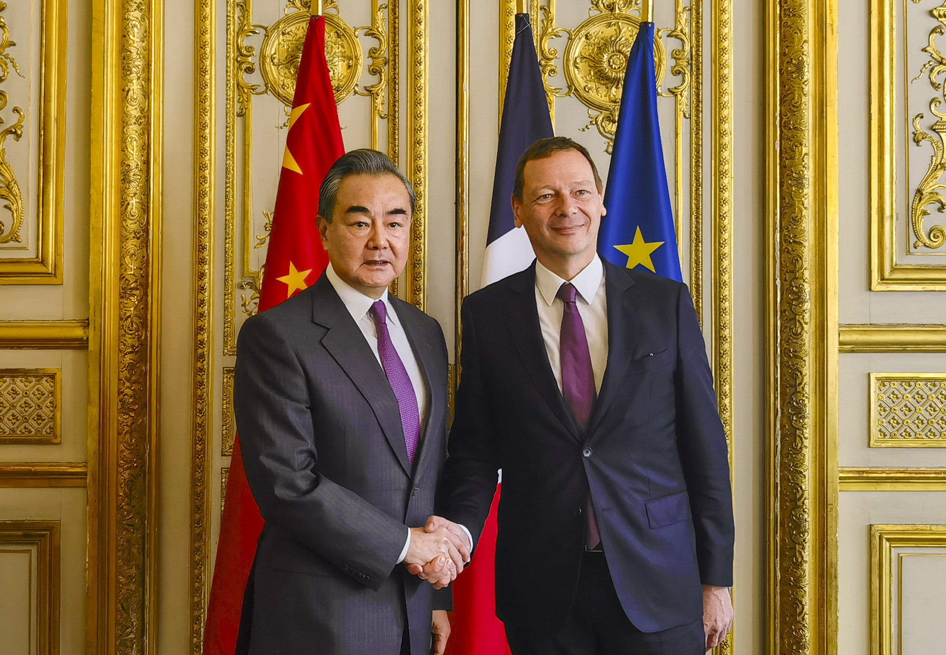 China’s top diplomat Wang Yi shakes hands with Emmanuel Bonne, diplomatic counsellor to the French president, in Paris on Thursday. Photo: Xinhua