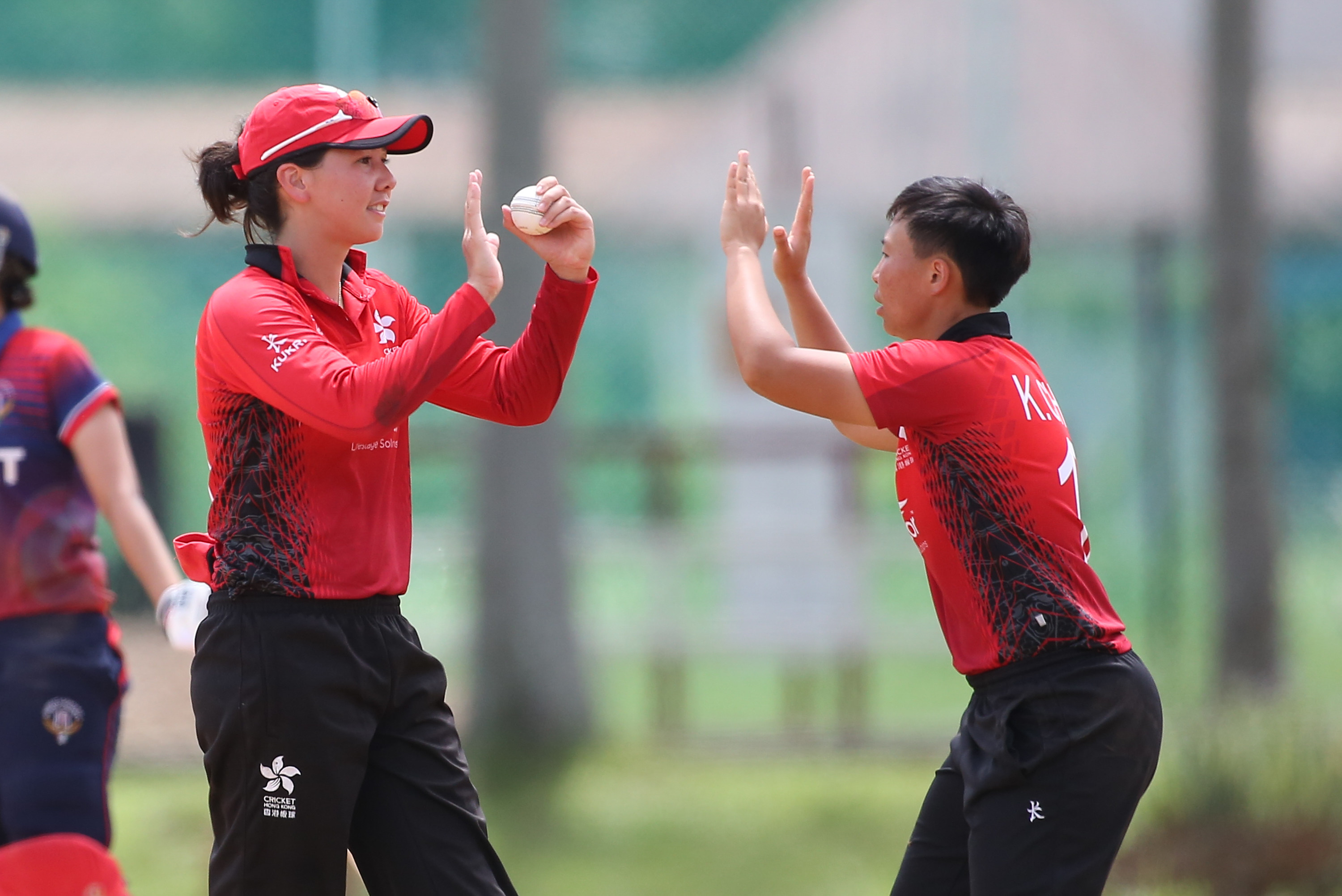 Natasha Miles (left) and Hong Kong captain Kary Chan celebrate after taking the wicket of Priyada Murali during a game in Malaysia. Photo: ACC