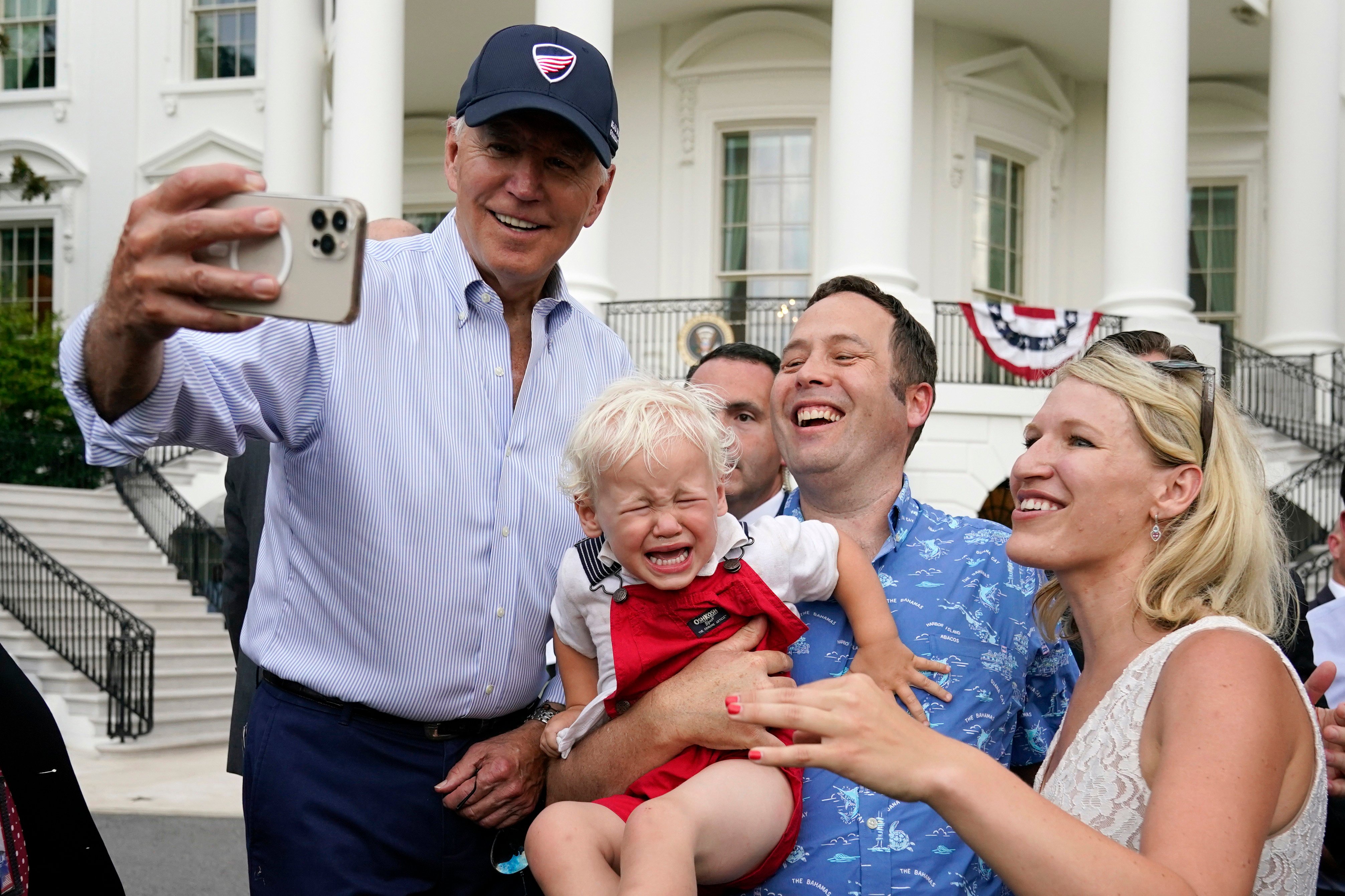 President Joe Biden takes a photo with guests at the White House Congressional Picnic on  July 12 in Washington. Most Americans think Biden has accomplished “not very much” or “little or nothing” during his first two years. Photo: AP